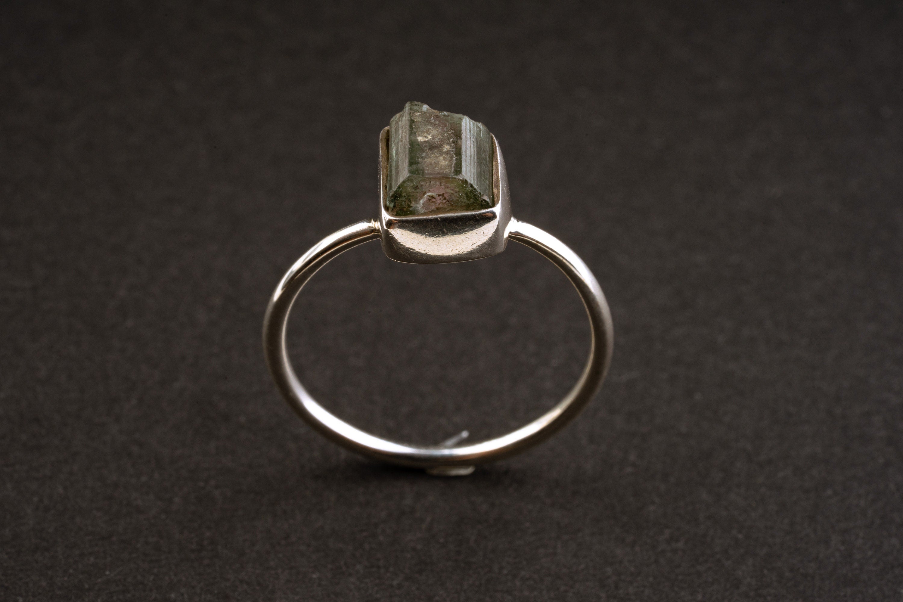 Watermelon Tourmaline sterling silver stack ring shown on a dark background, with colour-zoned crystal and fine silver band.