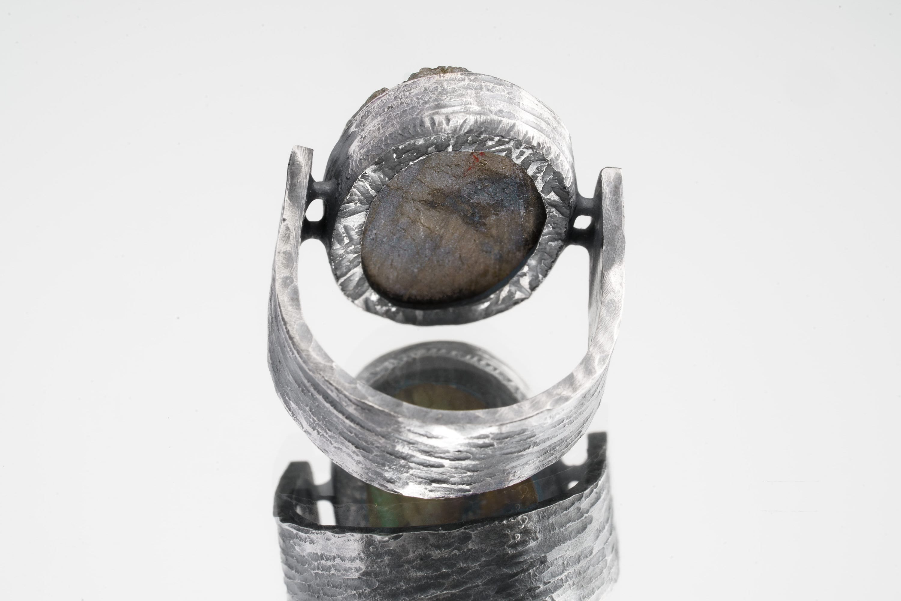 Back view of Mystic Oculus Labradorite ring showing U-shaped band, oxidized texture, and sculptural silver construction.