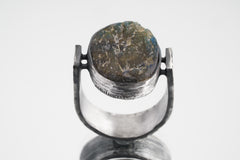 Front view of circular Labradorite ring showing U-shaped oxidized silver band and sculptural oculus setting.