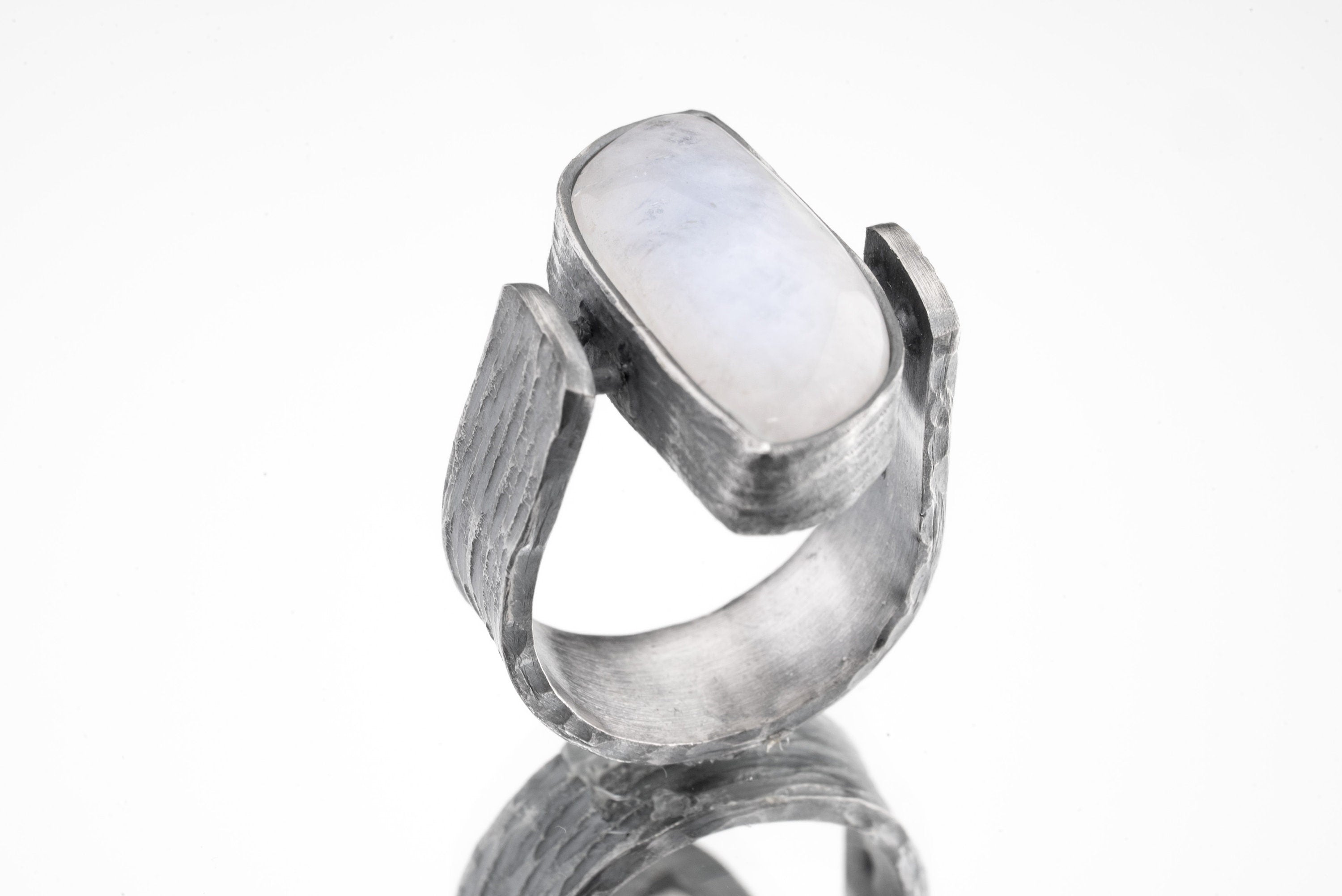 Lunar Sanctuary Moonstone ring in oxidized 925 sterling silver with rectangular glowing stone and bark-like texture.
