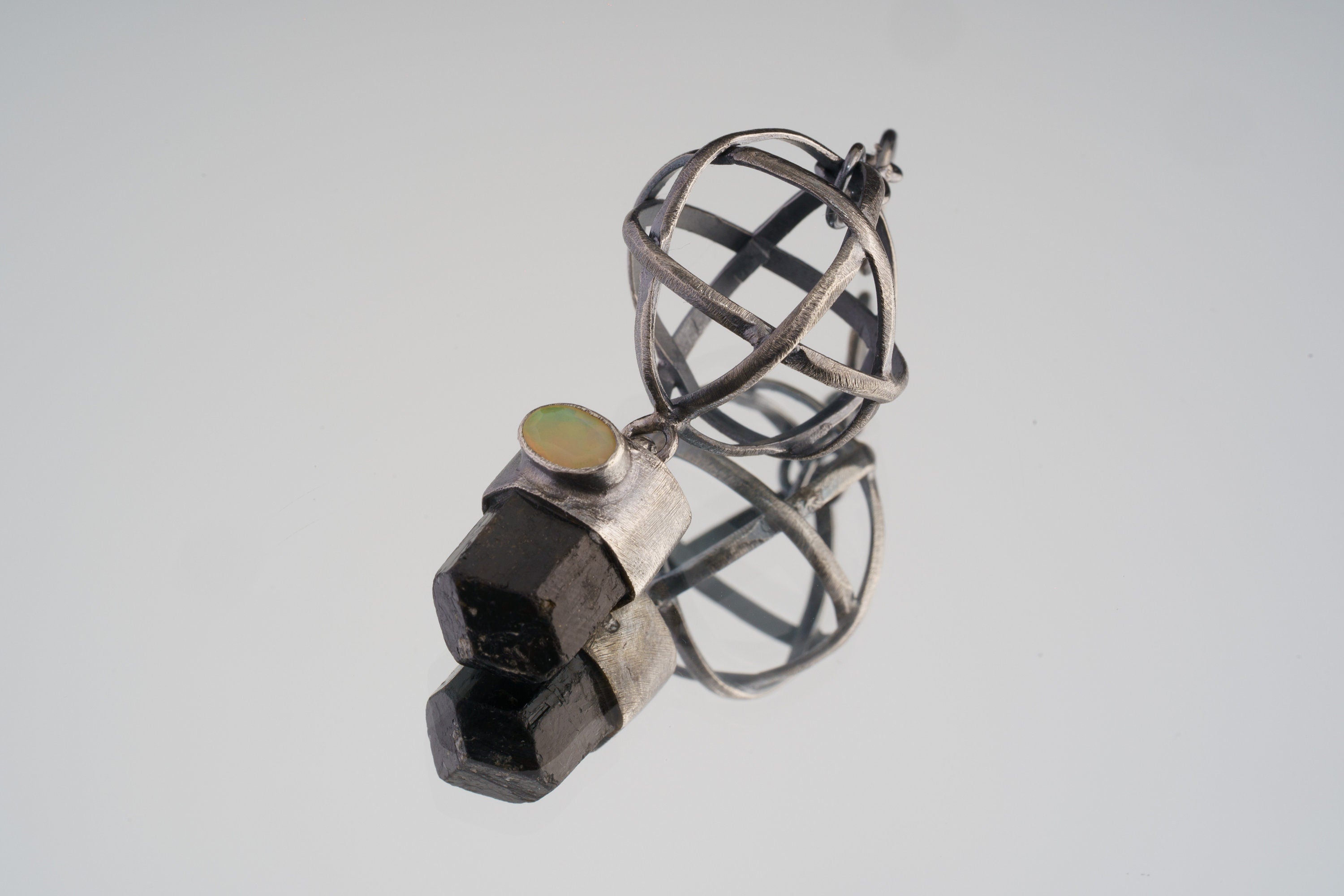 Himalayan Brown Tourmaline and Ethiopian Opal sphere pendant in oxidized 925 sterling silver, shown with Brutalist wire construction.