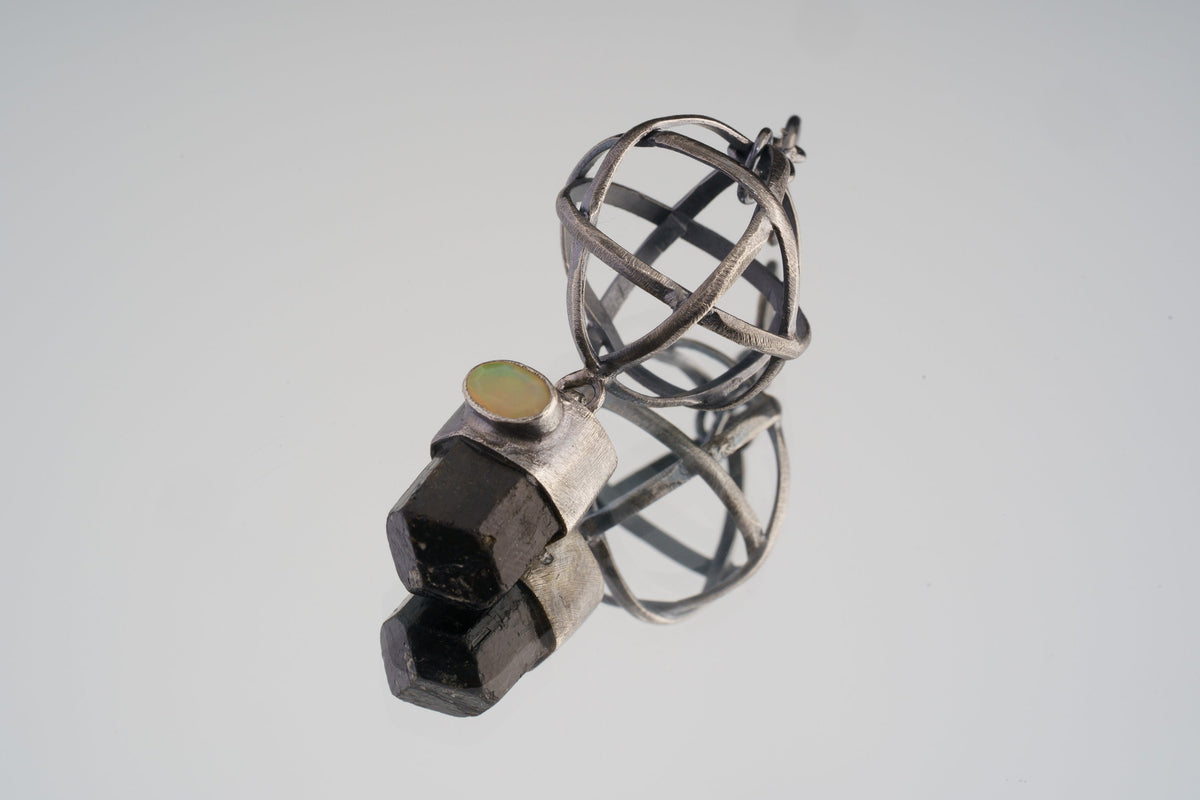 Himalayan Brown Tourmaline and Ethiopian Opal sphere pendant in oxidized 925 sterling silver, shown with Brutalist wire construction.