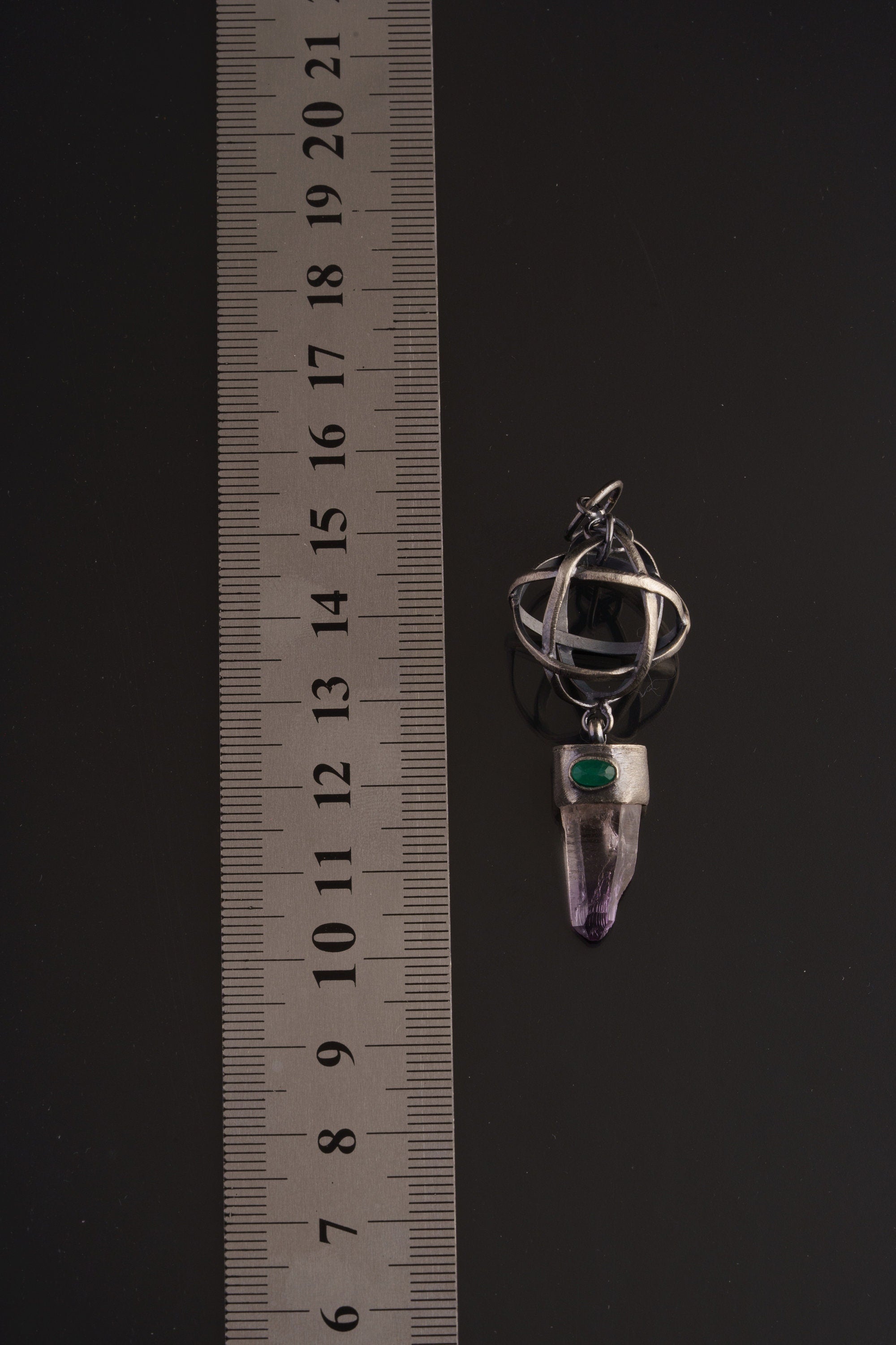 Vera Cruz Amethyst Emerald sphere pendant shown beside a ruler for scale, measuring approximately 5.5 to 6 cm long.