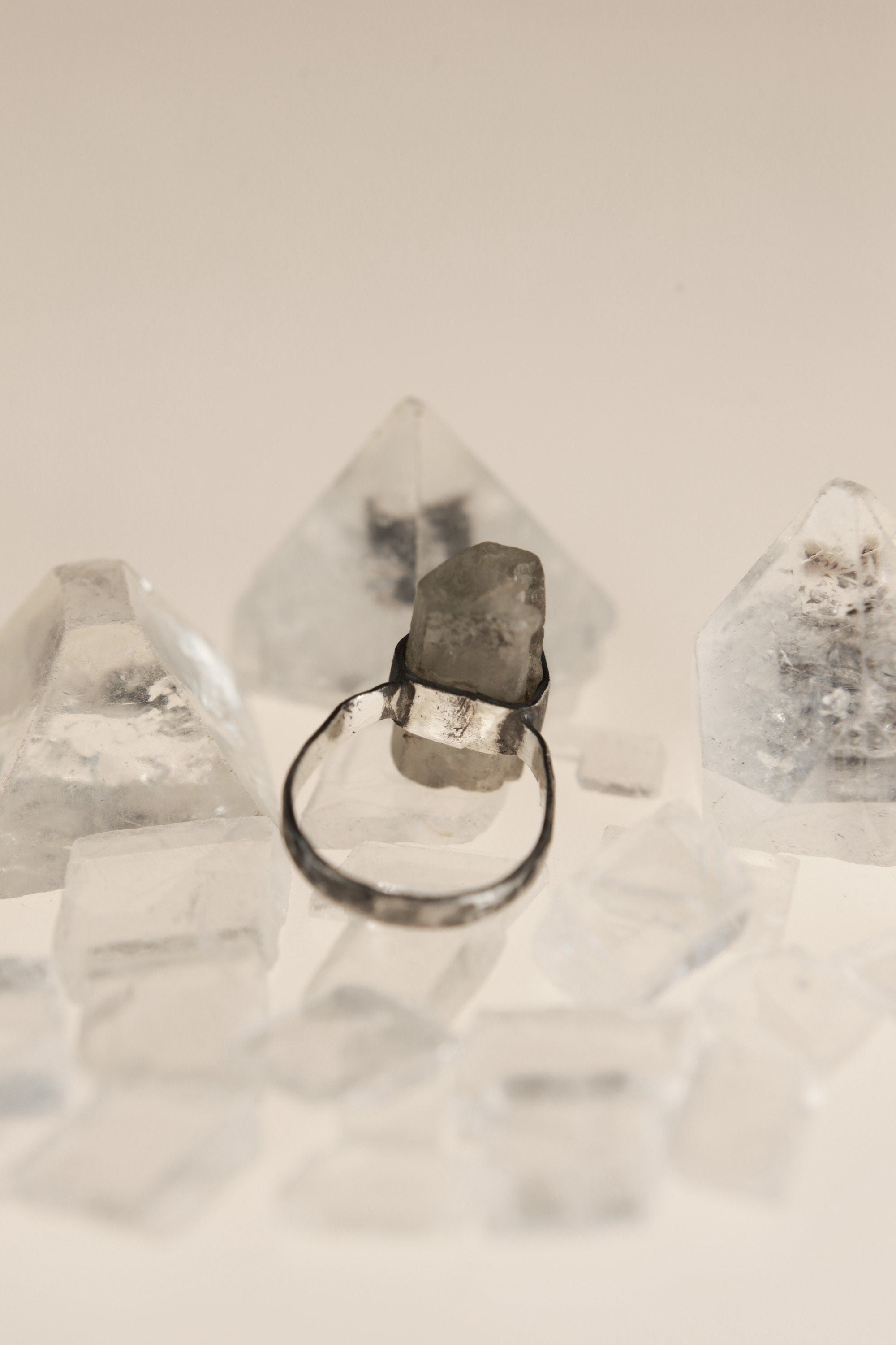 Back view of raw Aquamarine sterling silver ring showing the circular band, wrapped setting, and handmade oxidized finish.