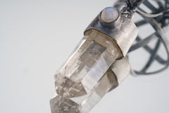 Close-up of Optical Grade Himalayan Lemurian Quartz point with Blue Moonstone set into an oxidized sterling silver cap.