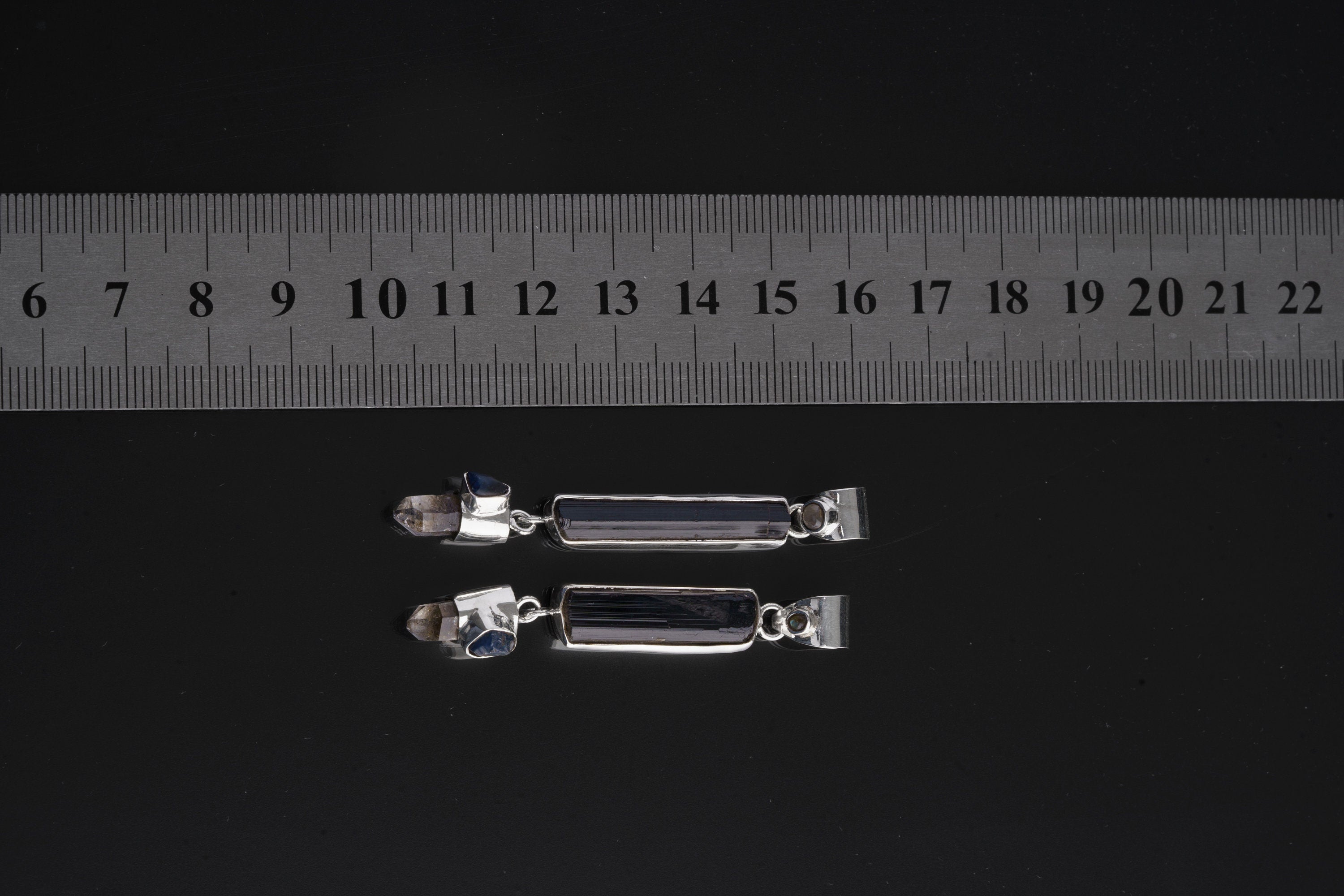 Celestial Earth Quartet pendant shown beside a ruler for scale with high-shine sterling silver finish.