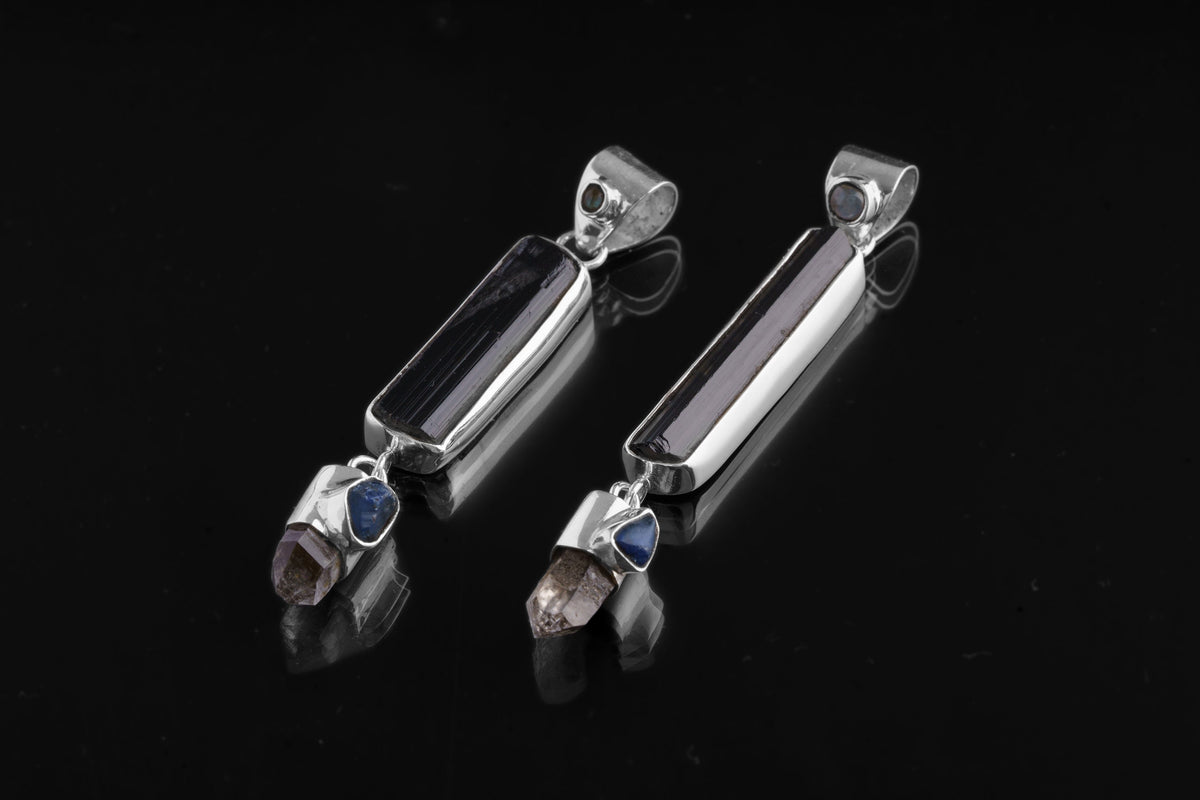 Blue Moonstone Tourmaline Smoky Quartz Sapphire pendant shown on dark background with high-shine sterling silver.