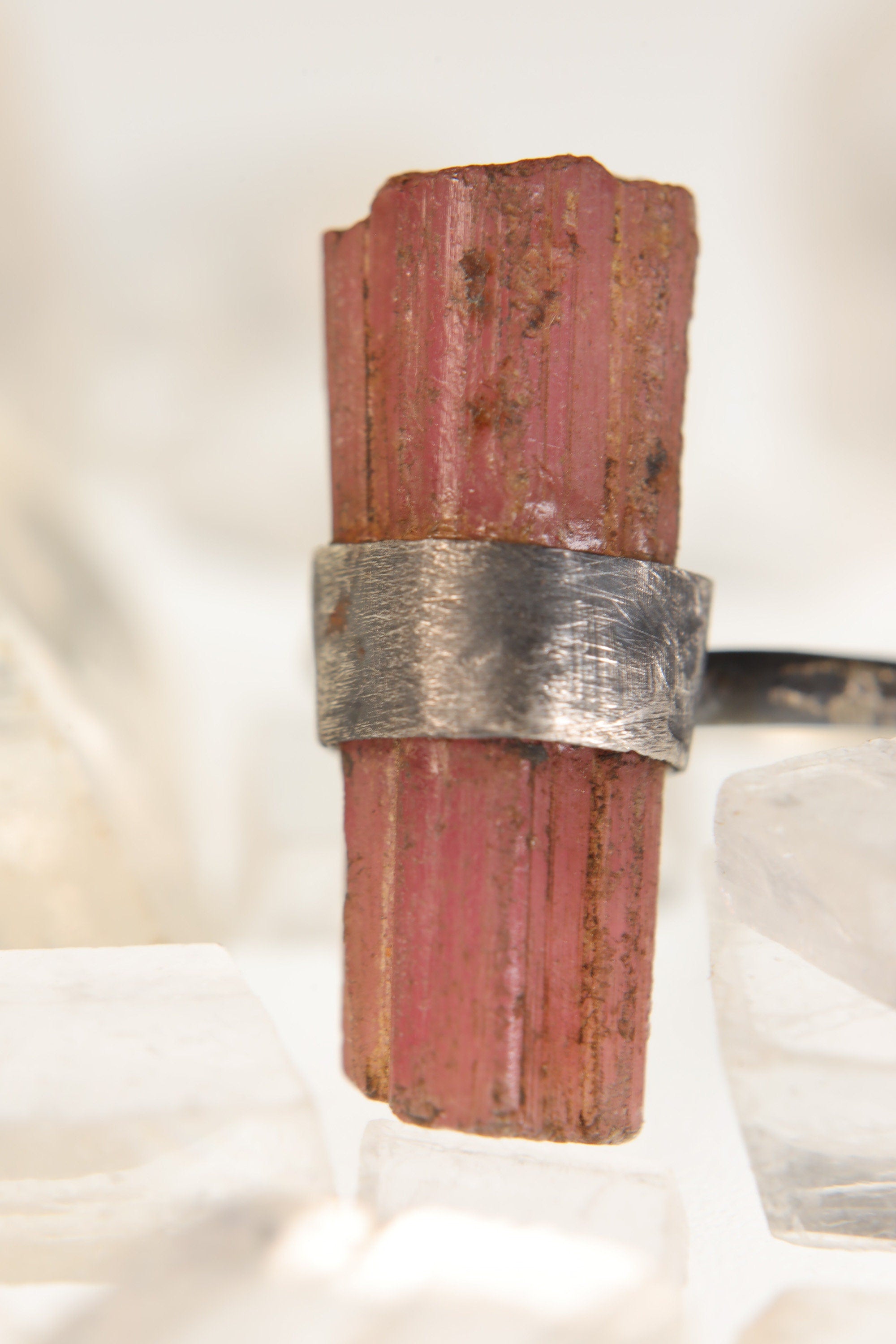 Close-up of raw Pink Tourmaline ring showing natural crystal texture and wrapped sterling silver setting.