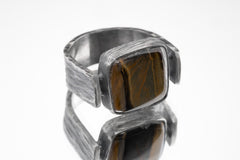 Side view of Tiger Eye ring showing bark-like oxidized silver texture, coiled supports, and raised rectangular stone.