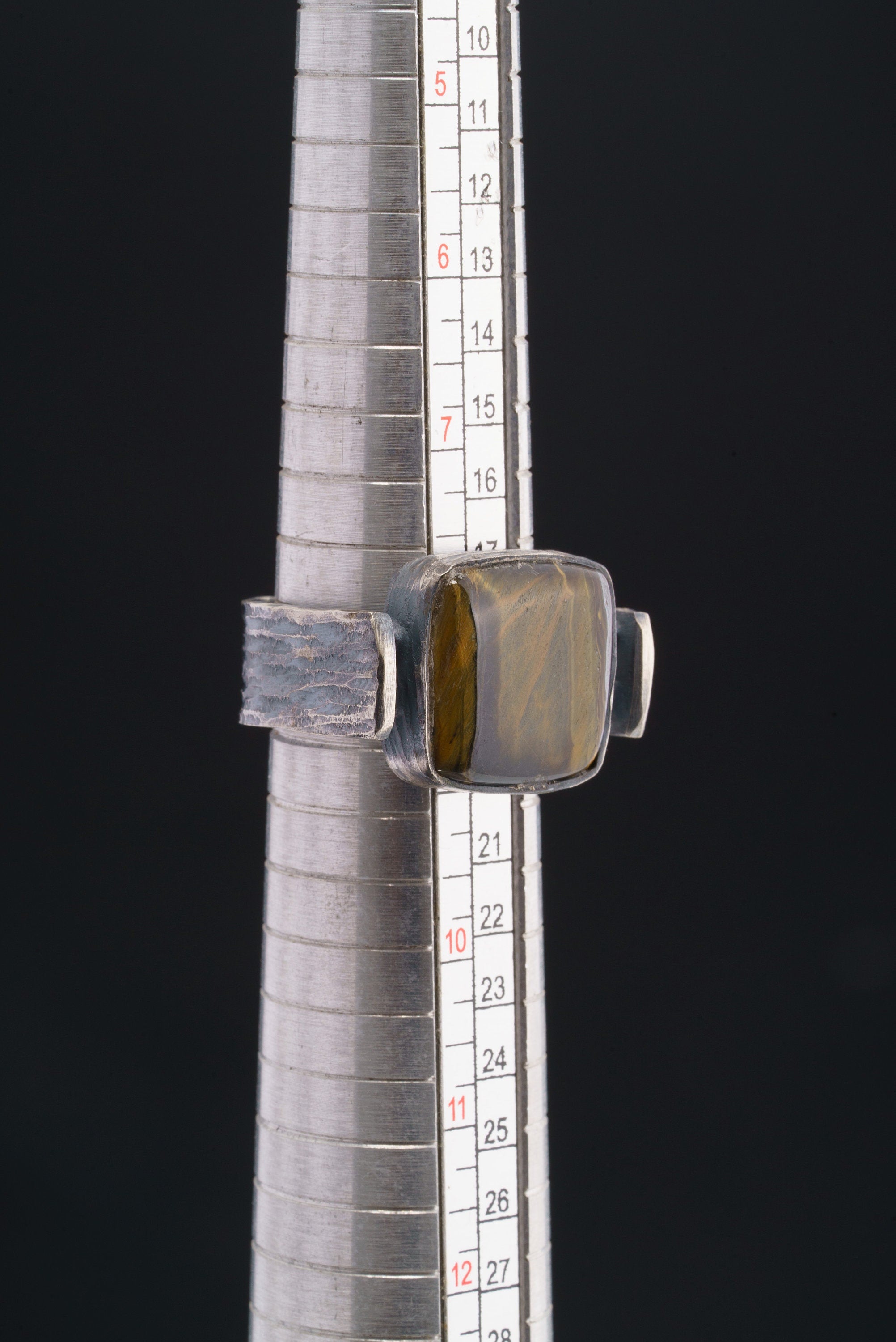 Tiger Eye brutalist ring shown beside a ruler for scale, with oxidized 925 sterling silver and rectangular gemstone.