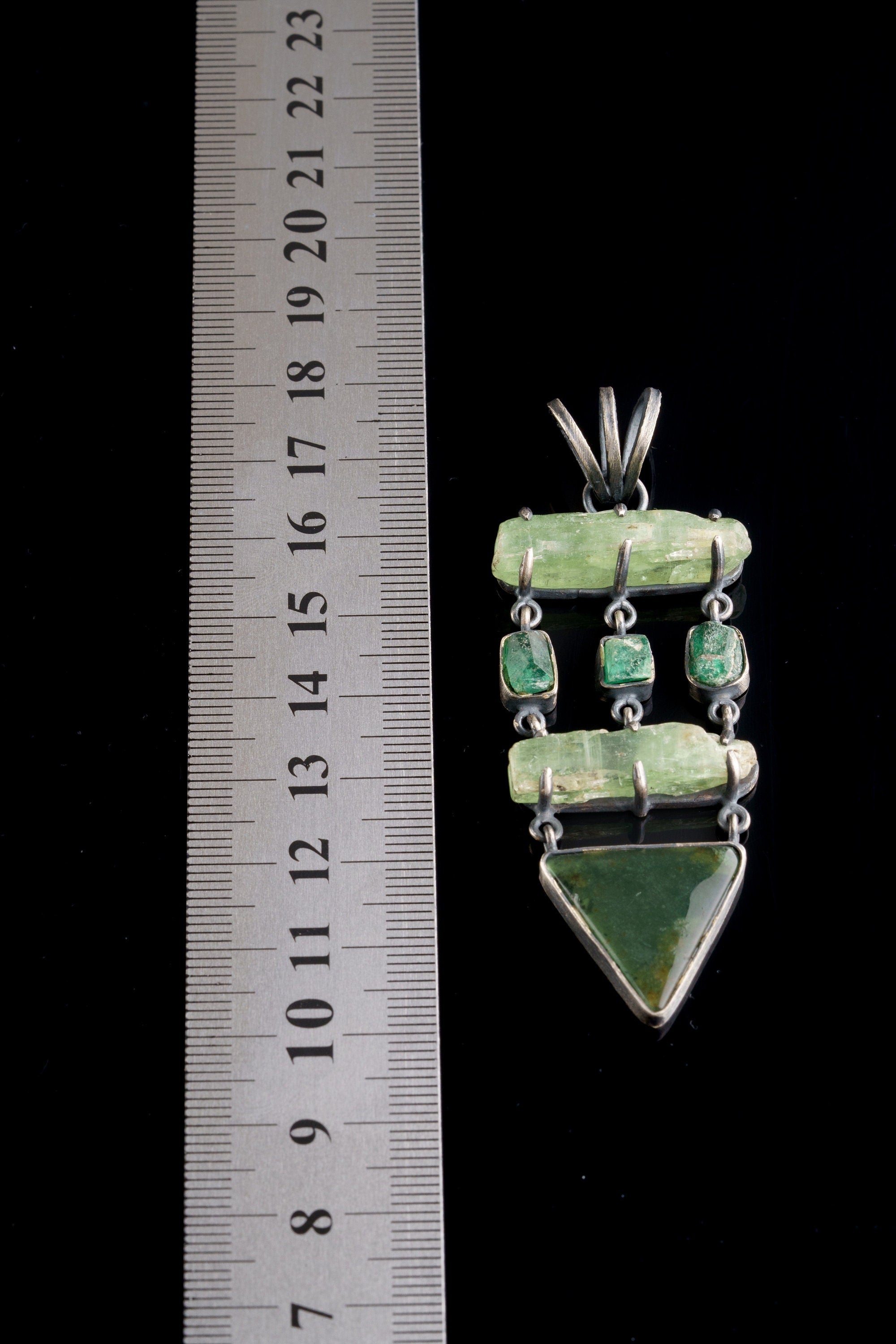 Green Kyanite Emerald Chrysoprase pendant shown beside a ruler for scale, with layered green gemstones and oxidized silver.