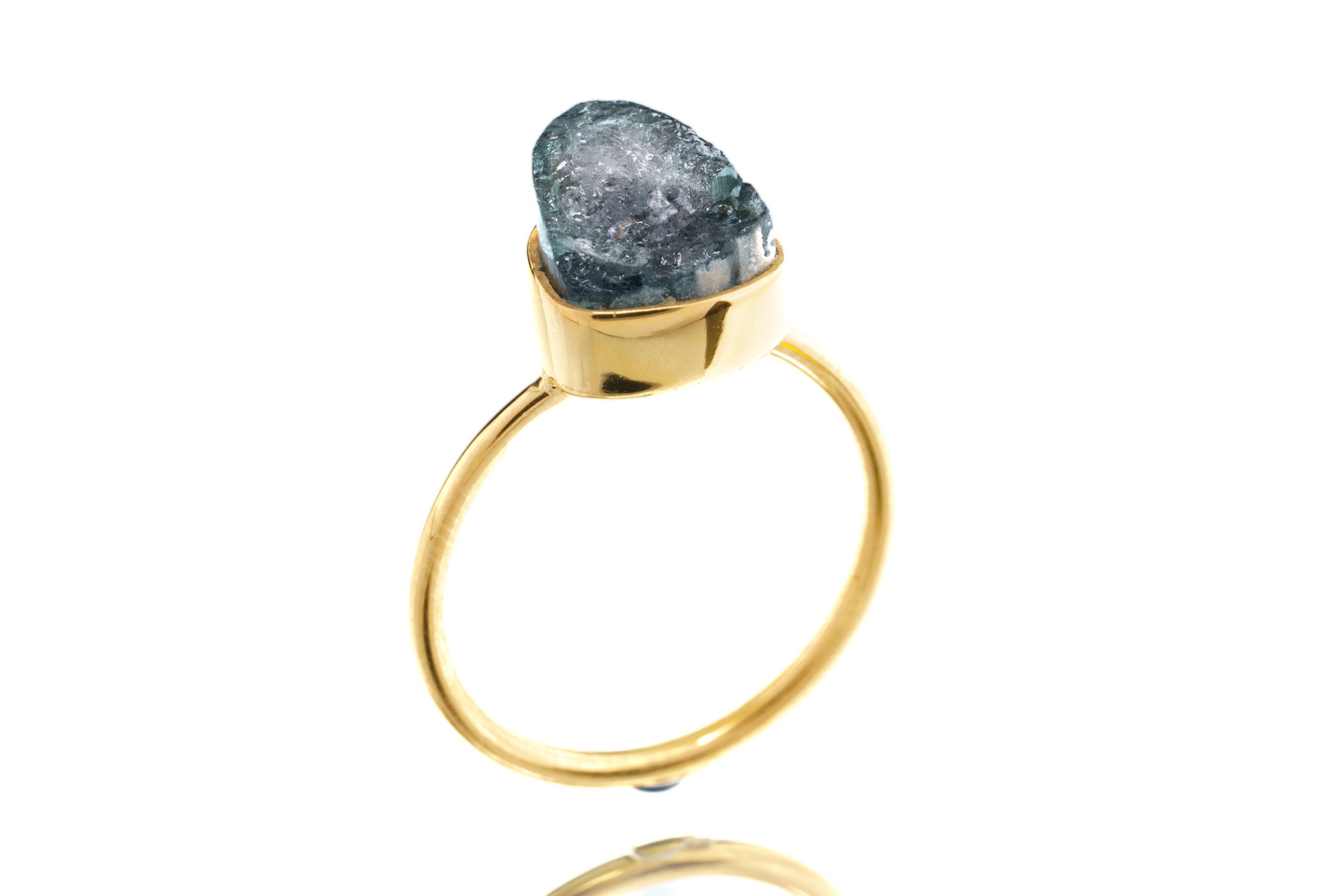 Side view of Blue Tourmaline stacking ring showing the raised teal stone and slim gold-plated sterling silver band.