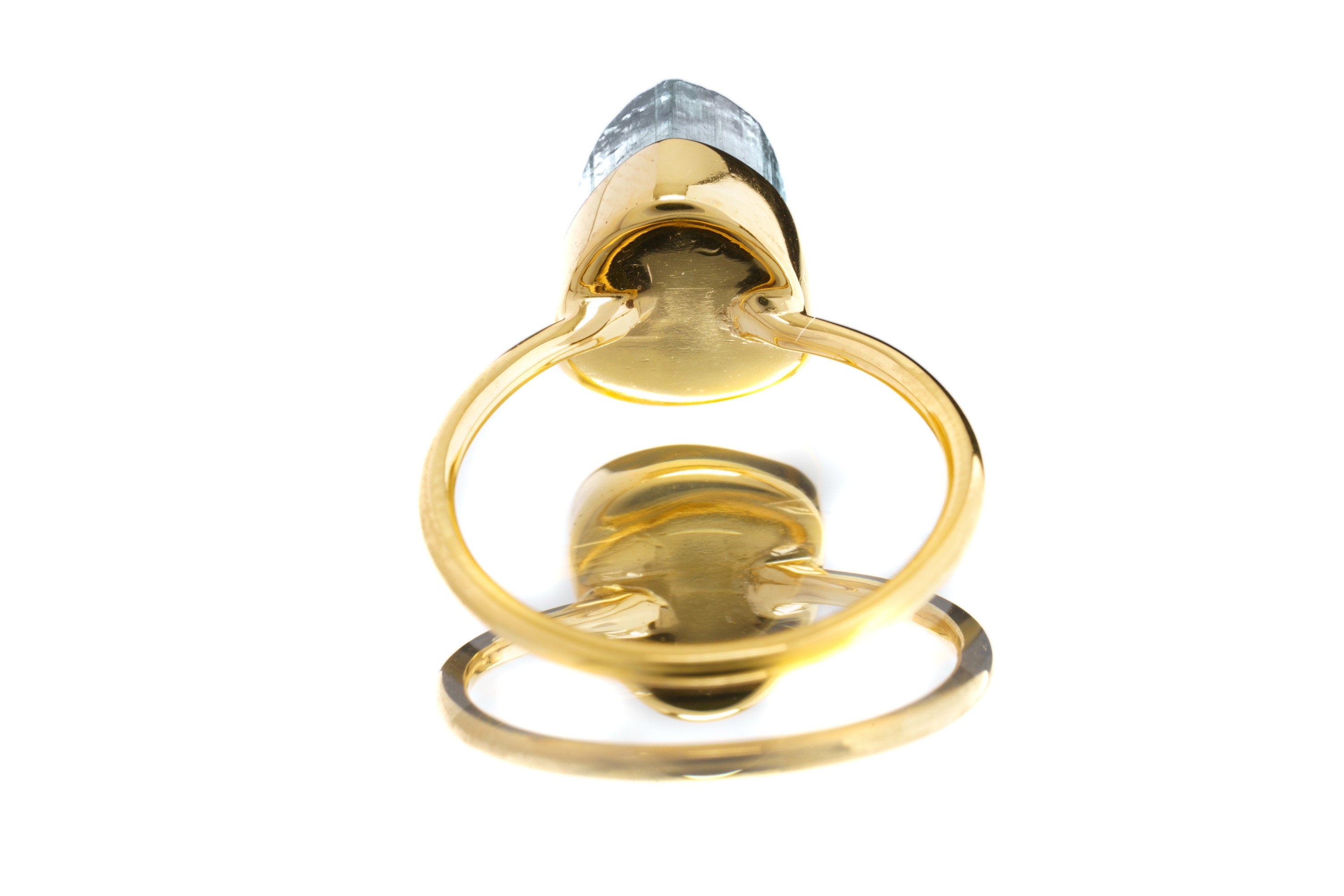 Gold-plated Blue Tourmaline Indicolite ring shown on a light background, with deep teal gemstone and stacking band.