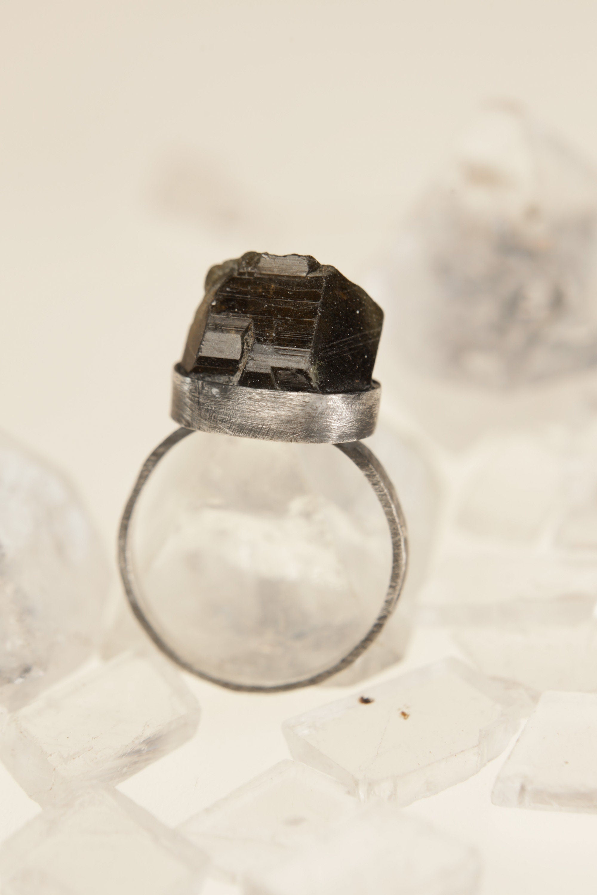 Side view of raw Dioptase set in oxidized sterling silver bezel.