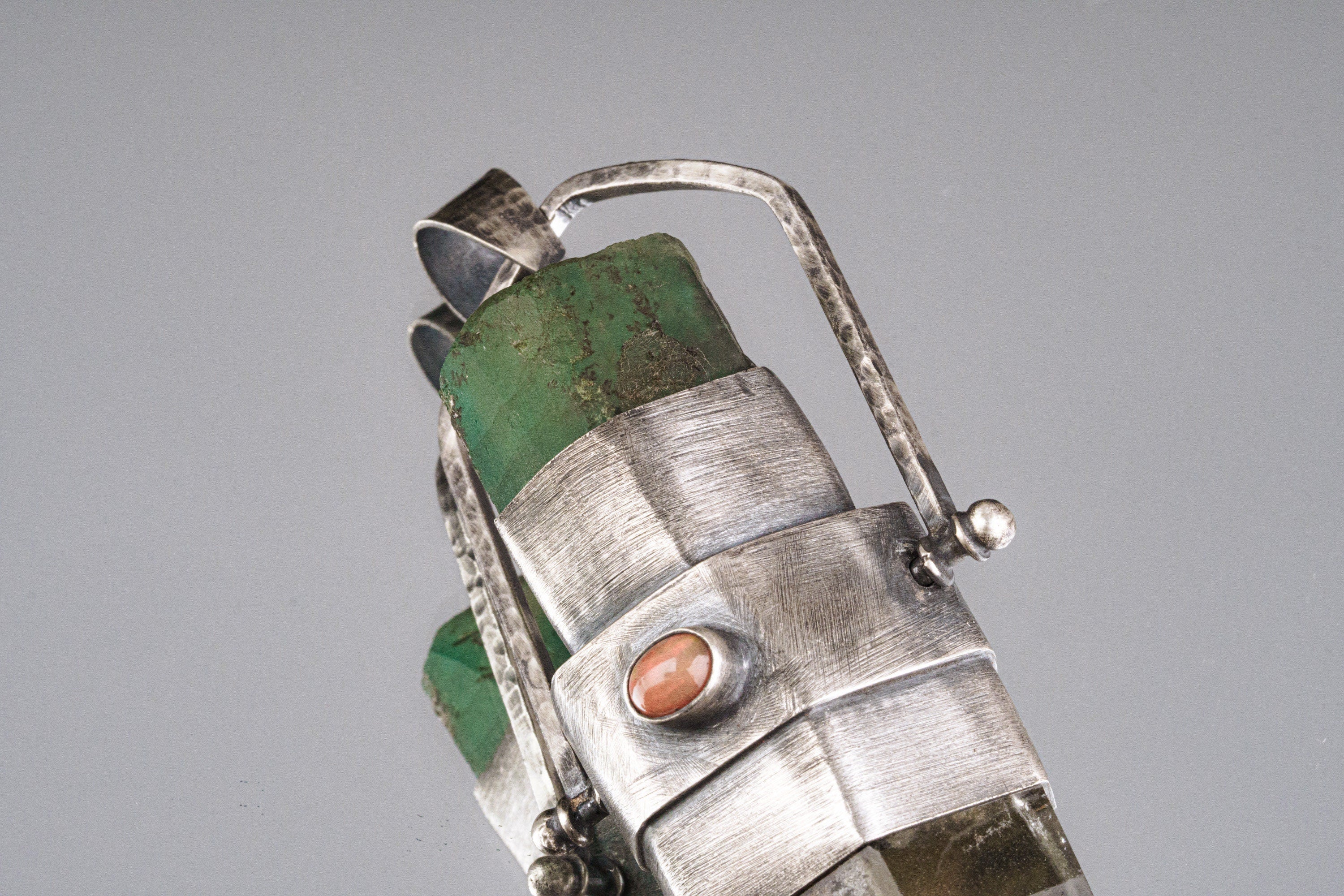 Close-up of Australian Emerald side of a large oxidized sterling silver spinner pendant with thick handmade bezel.