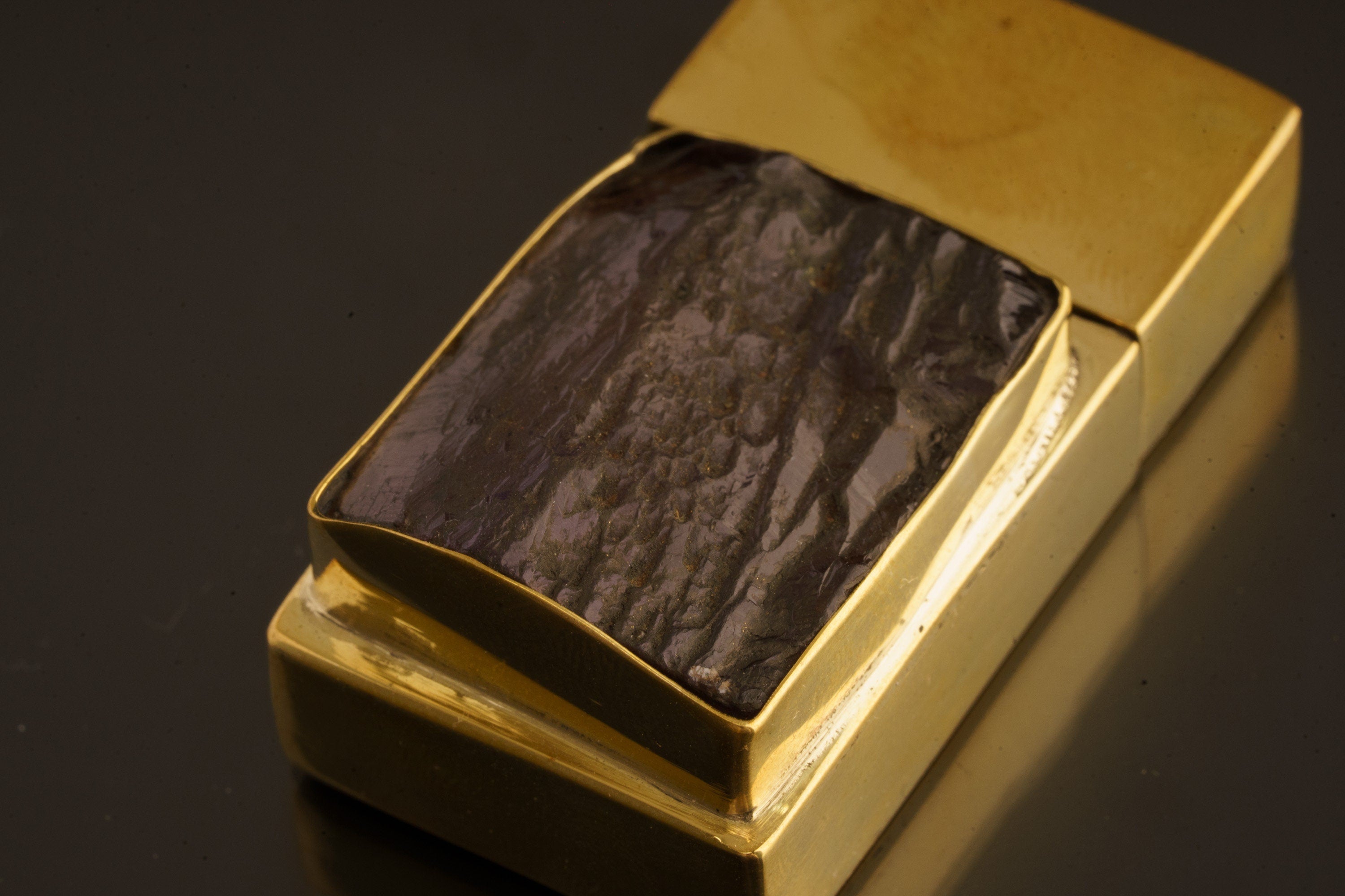 Amethyst brass keepsake box shown from above with gemstone lid detail and compact matchbox shape.