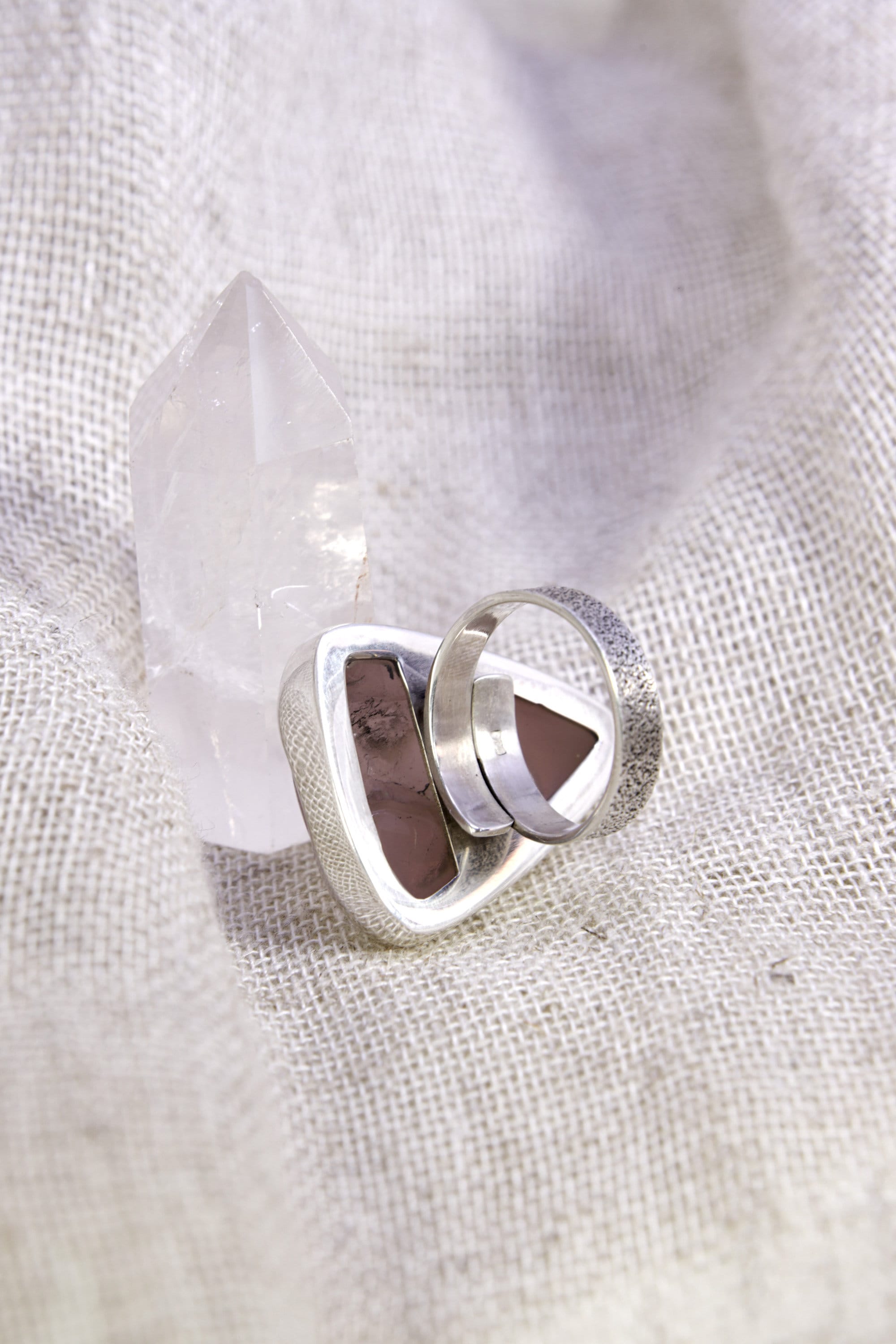 Back view of Rose Quartz adjustable ring showing open sterling silver band and carved-out support plate beneath the stone.
