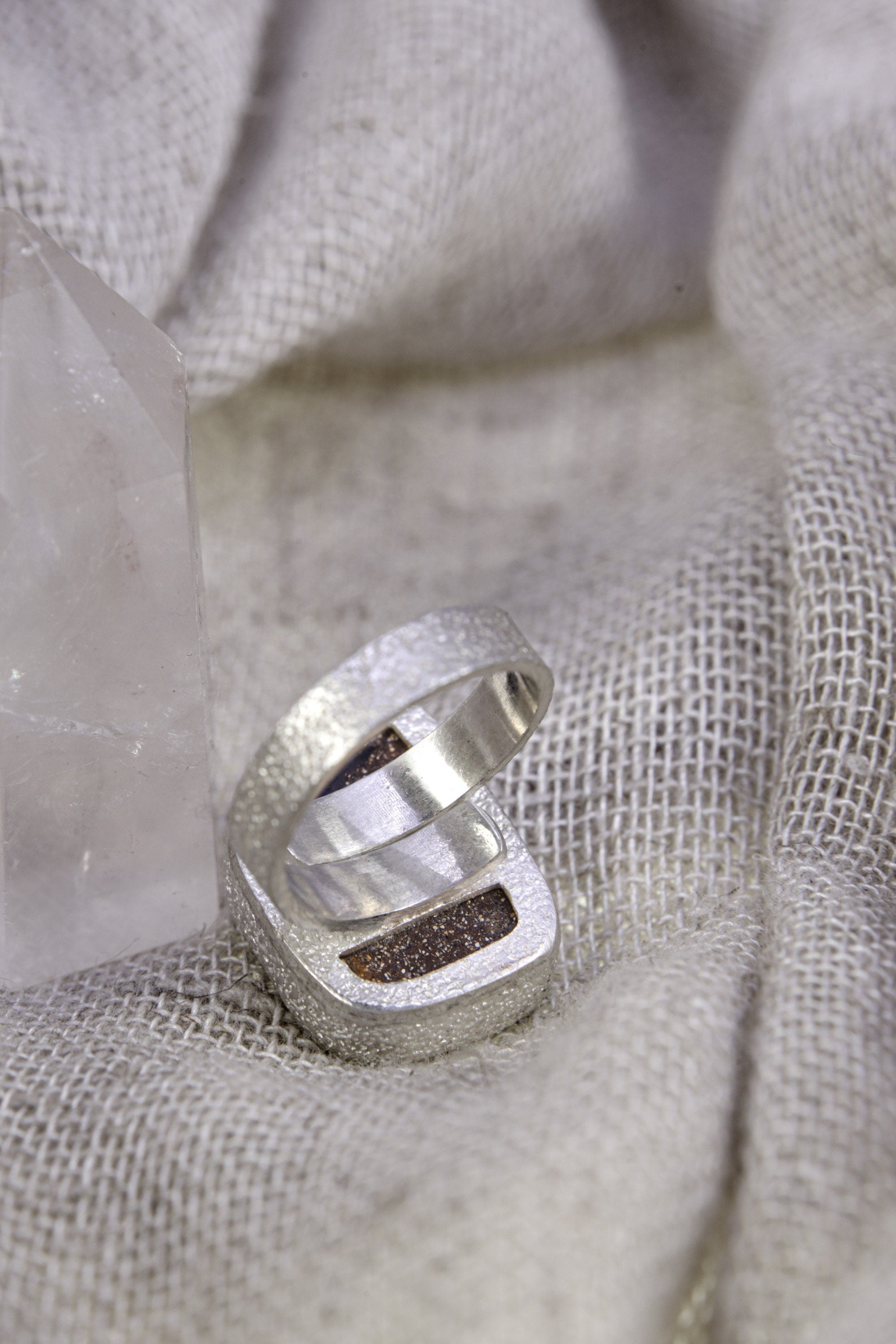 Back view of square Opal adjustable ring showing open sterling silver band and cut-out support plate beneath the setting.