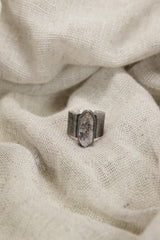 Vera Cruz Amethyst ring shown on soft fabric, with oxidized sterling silver and subtle twilight-purple crystal.