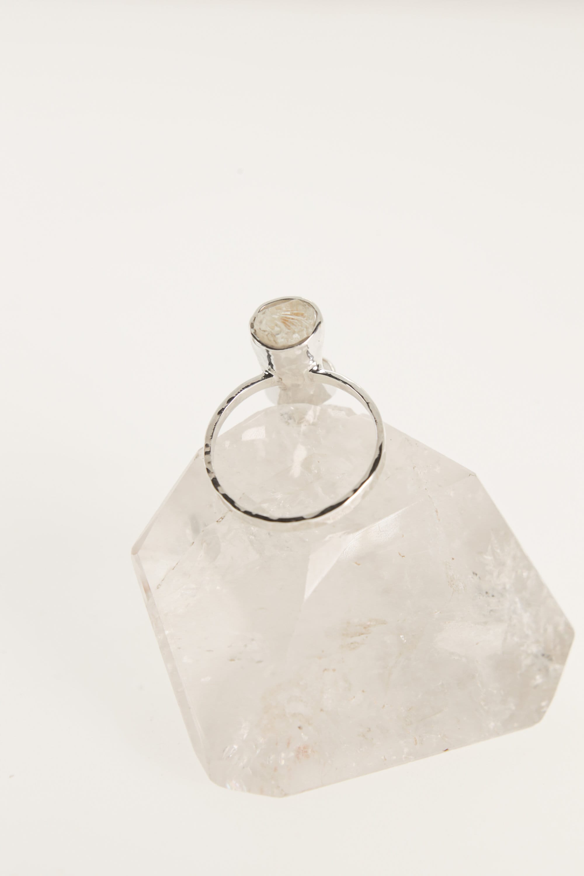 Back view of raw Aquamarine ring showing the circular sterling silver band and handmade crystal setting.