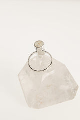 Back view of raw Aquamarine ring showing the circular sterling silver band and handmade crystal setting.