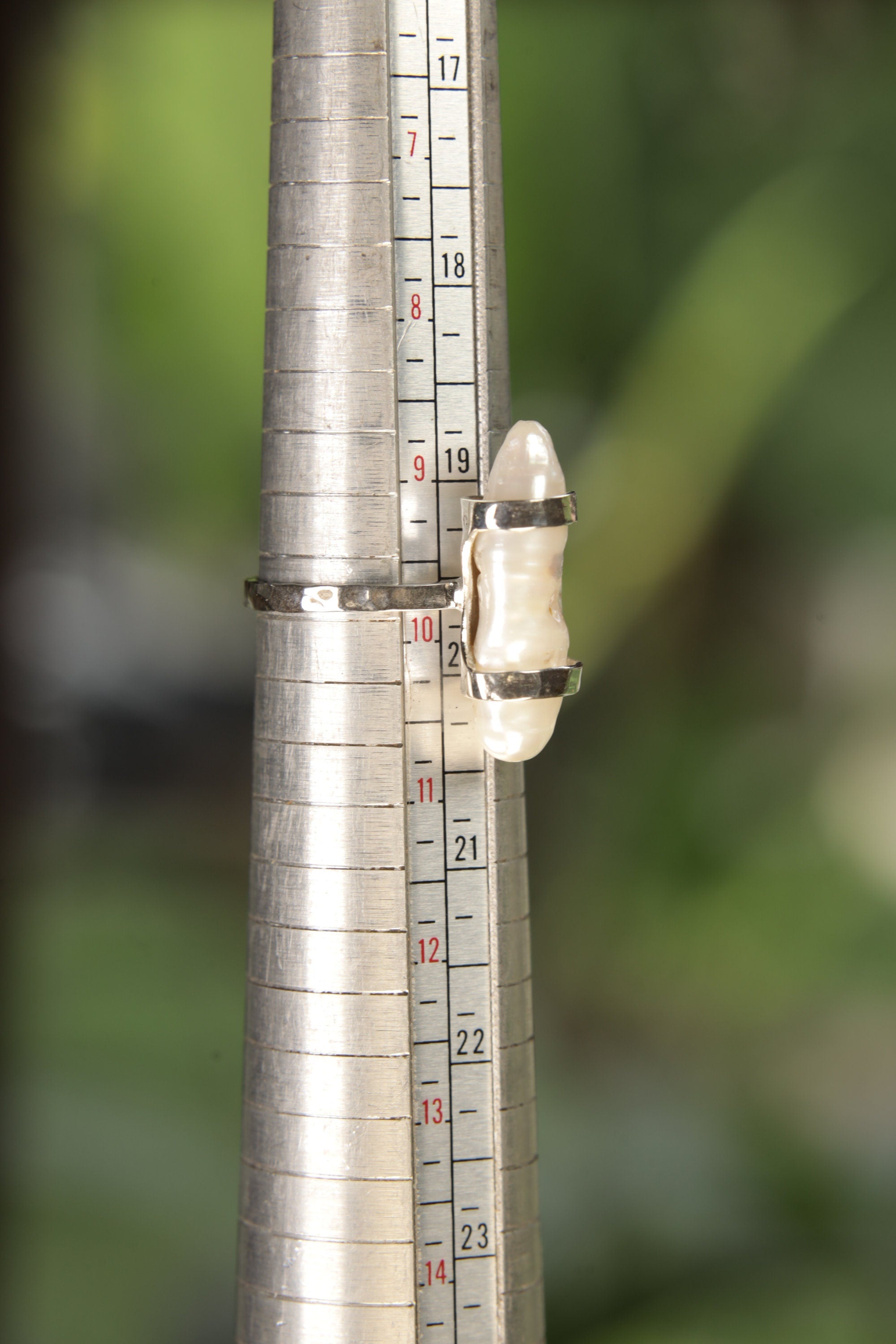 Mother of Pearl oxidized sterling silver ring shown on a mandrel for size reference, appearing around US size 9.5 to 10.