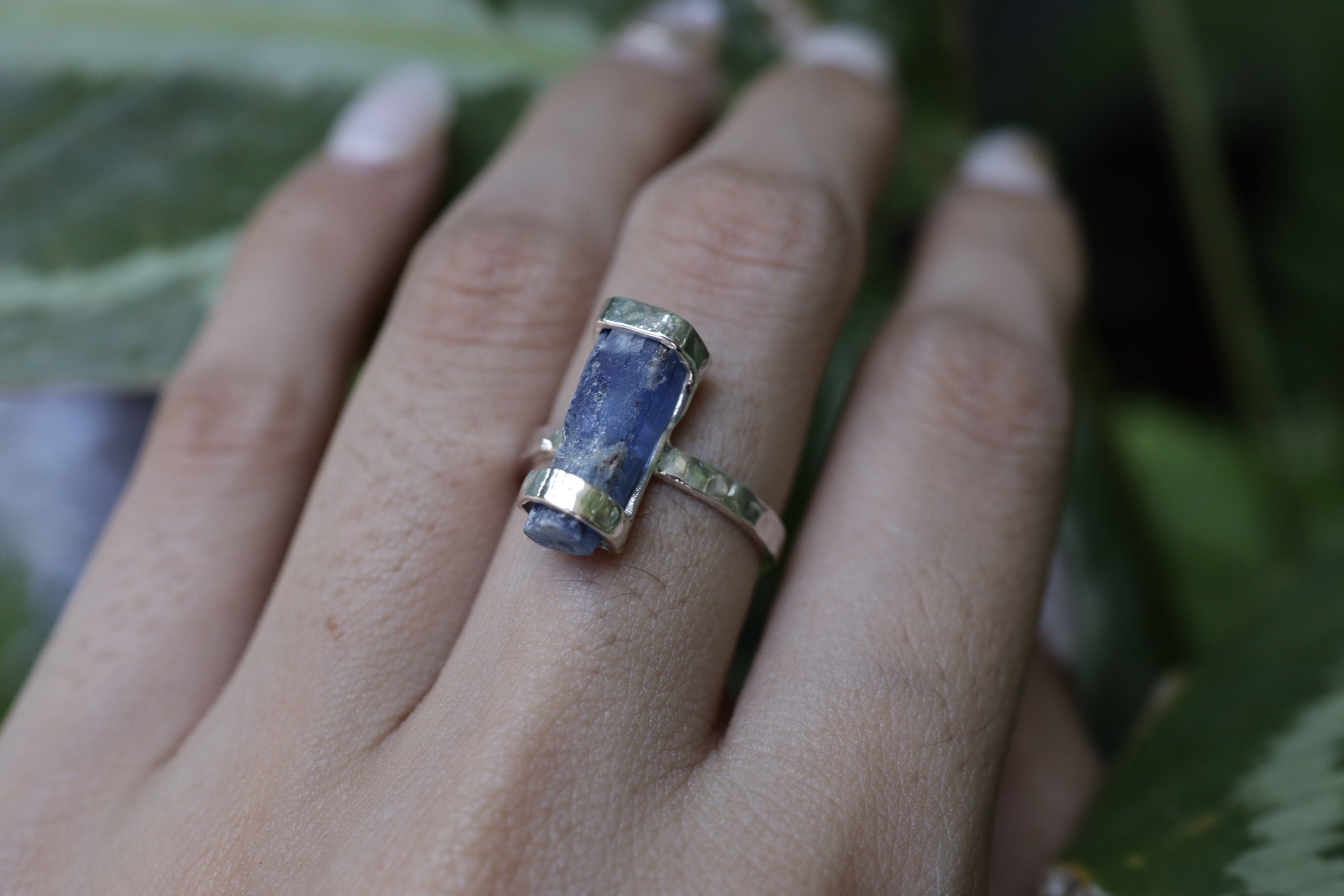 Ocean Kyanite ring shown worn on a hand, featuring deep blue Australian Kyanite and hammer-textured sterling silver.