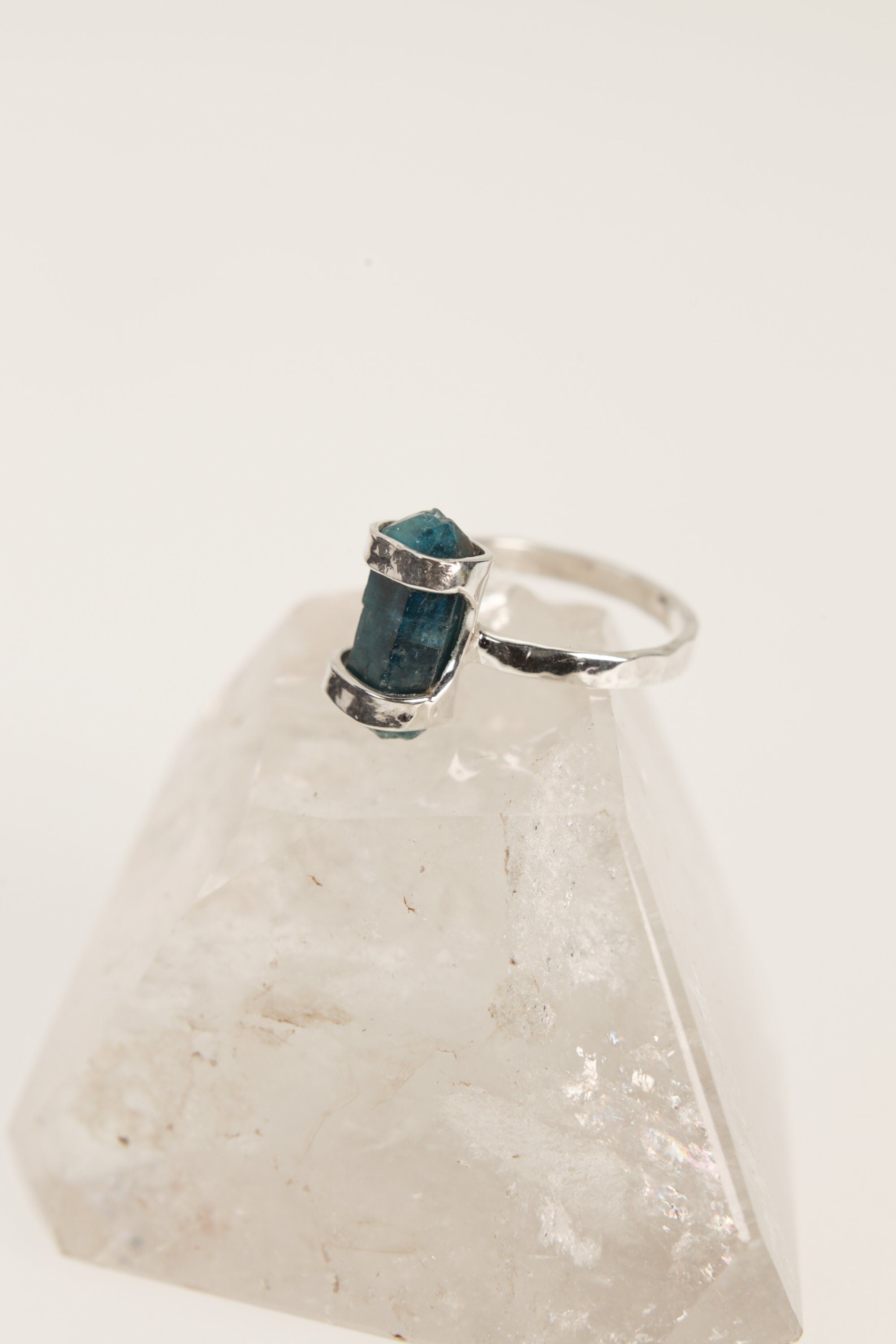 Close-up of Blue Apatite ring worn on the hand, with vivid azure crystal colour and oxidized sterling silver texture.
