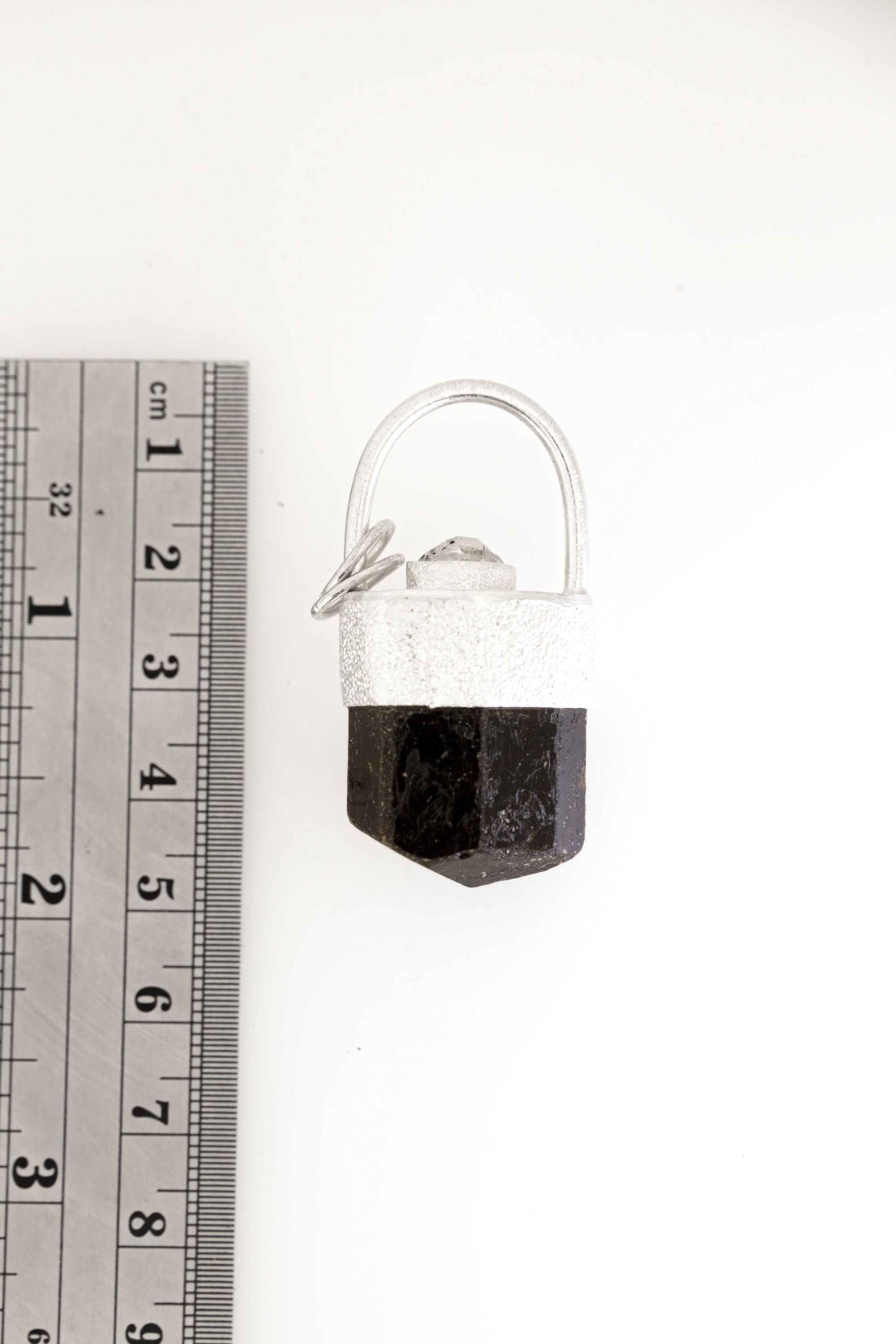 Himalayan Brown Dravite Tourmaline Diamond pendant shown beside a ruler for scale, measuring approximately 4.5 to 5 cm long.