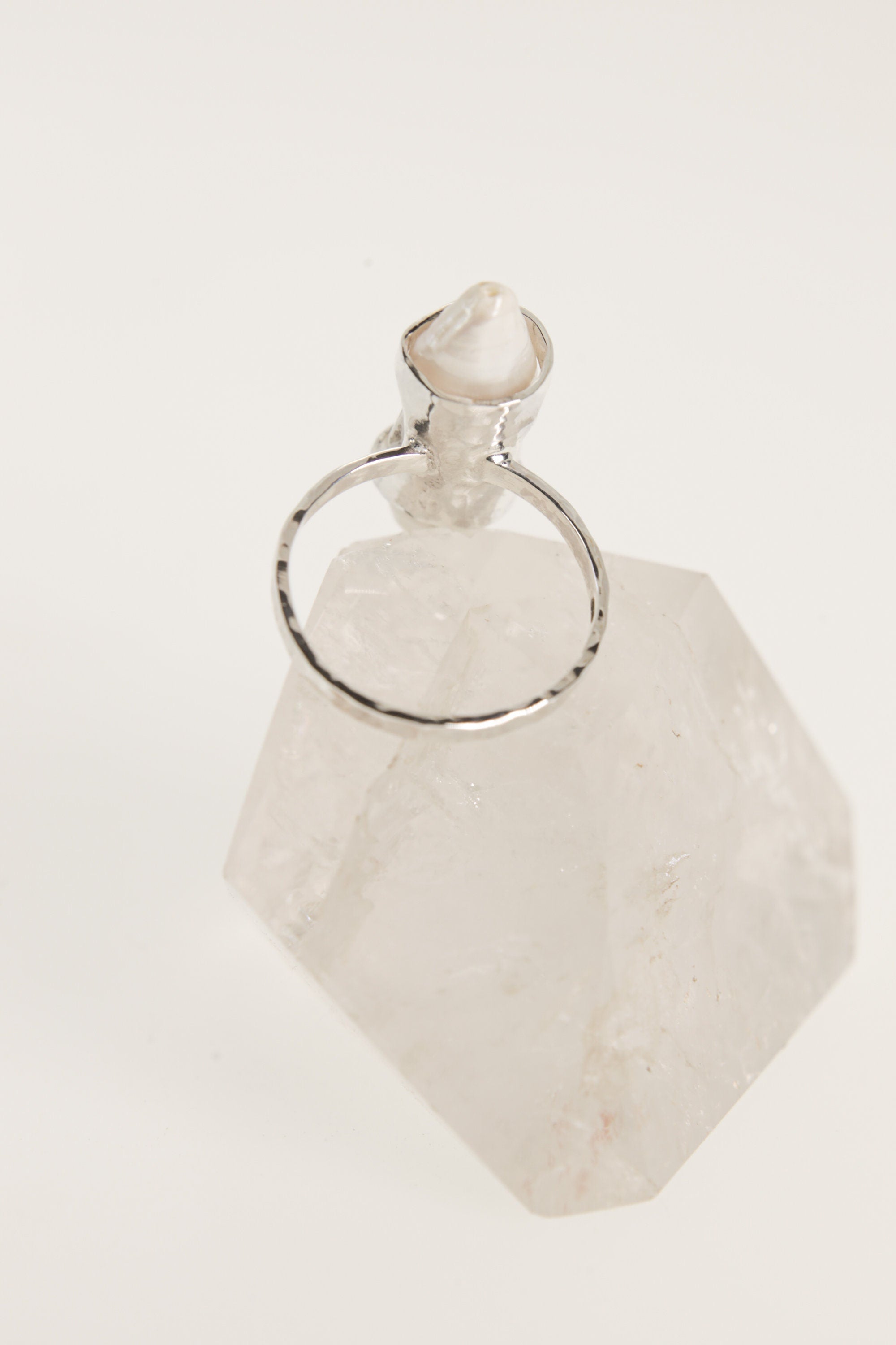 Back view of Mother of Pearl sterling silver ring showing the circular band, raised setting, and oxidized handmade finish.