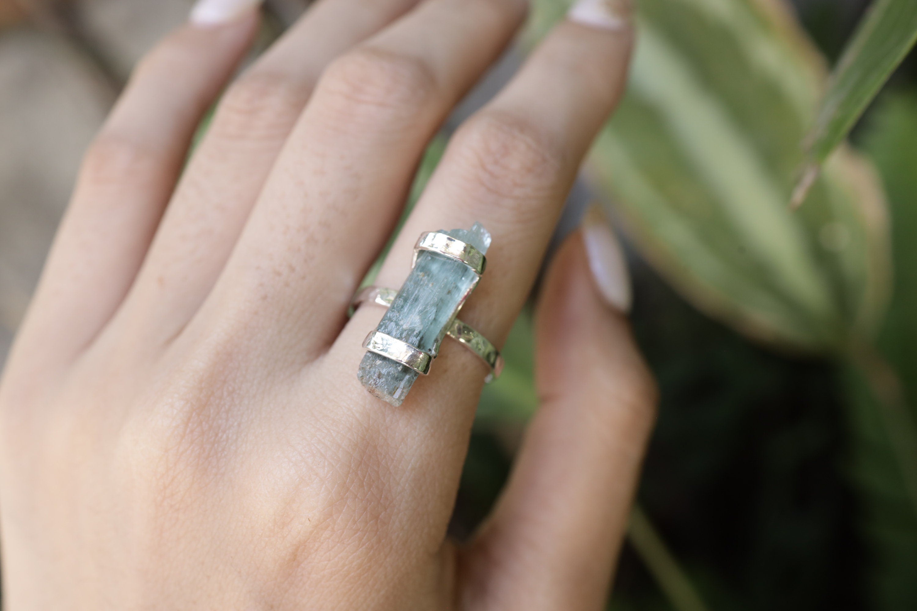 Himalayan Aquamarine ring shown worn on the hand as a calm blue Throat Chakra gemstone ring in oxidized silver.