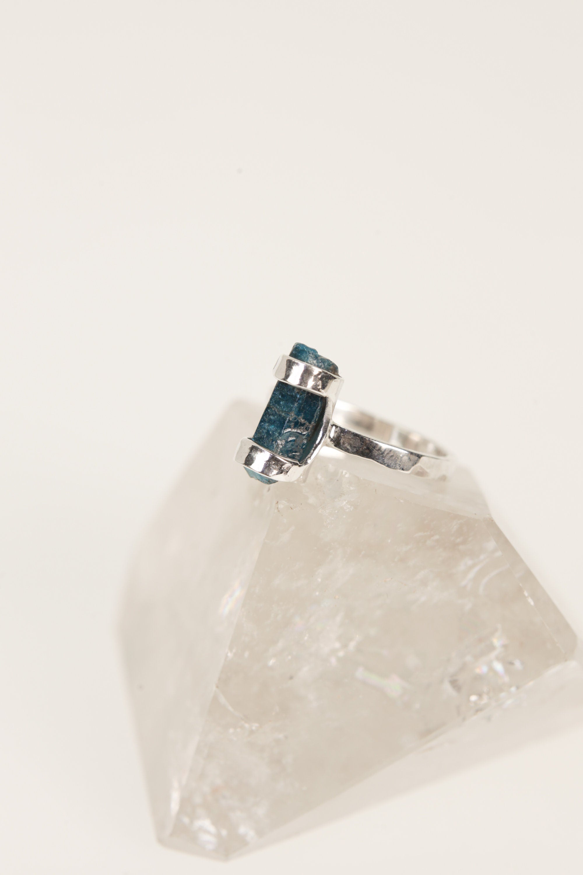 Blue Apatite silver ring shown worn on a hand, with vivid blue crystal and rugged oxidized handmade band.