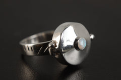 Opal Box Ring shown on black background with high-polish sterling silver box top and sculptural ring form.