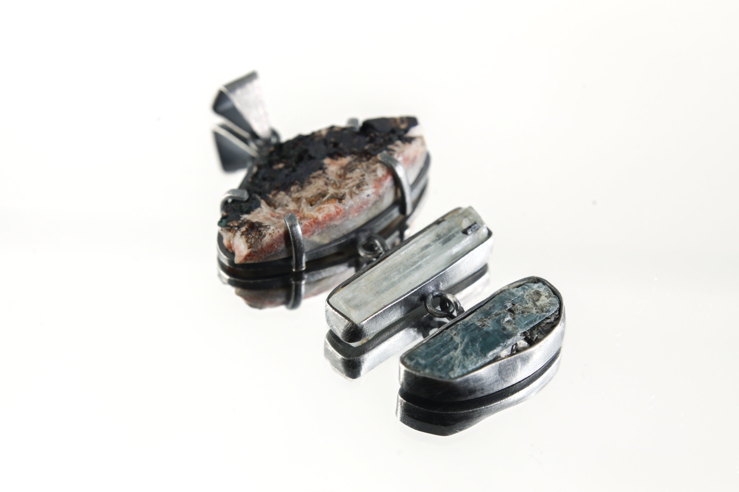 Ocean Mind Azurite Aquamarine Kyanite pendant shown on white background with raw blue gemstone layers.