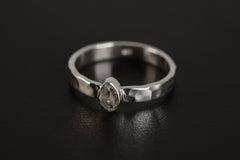 Petite Herkimer Diamond Ring shown on black background with raw double-terminated Quartz and polished silver band.
