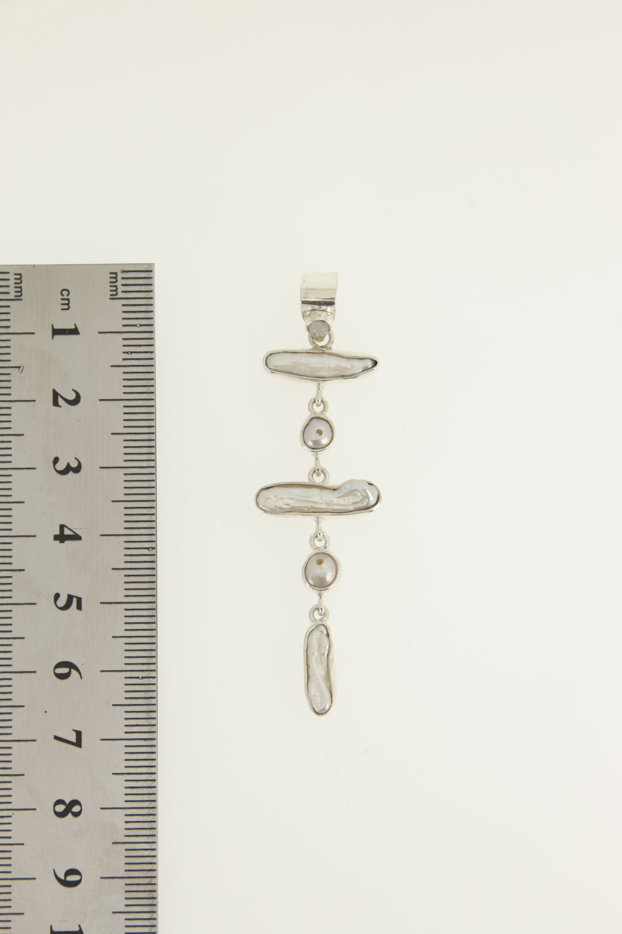 Blue Moonstone and Pearl cascade pendant shown beside a ruler for scale, measuring approximately 6 cm long.