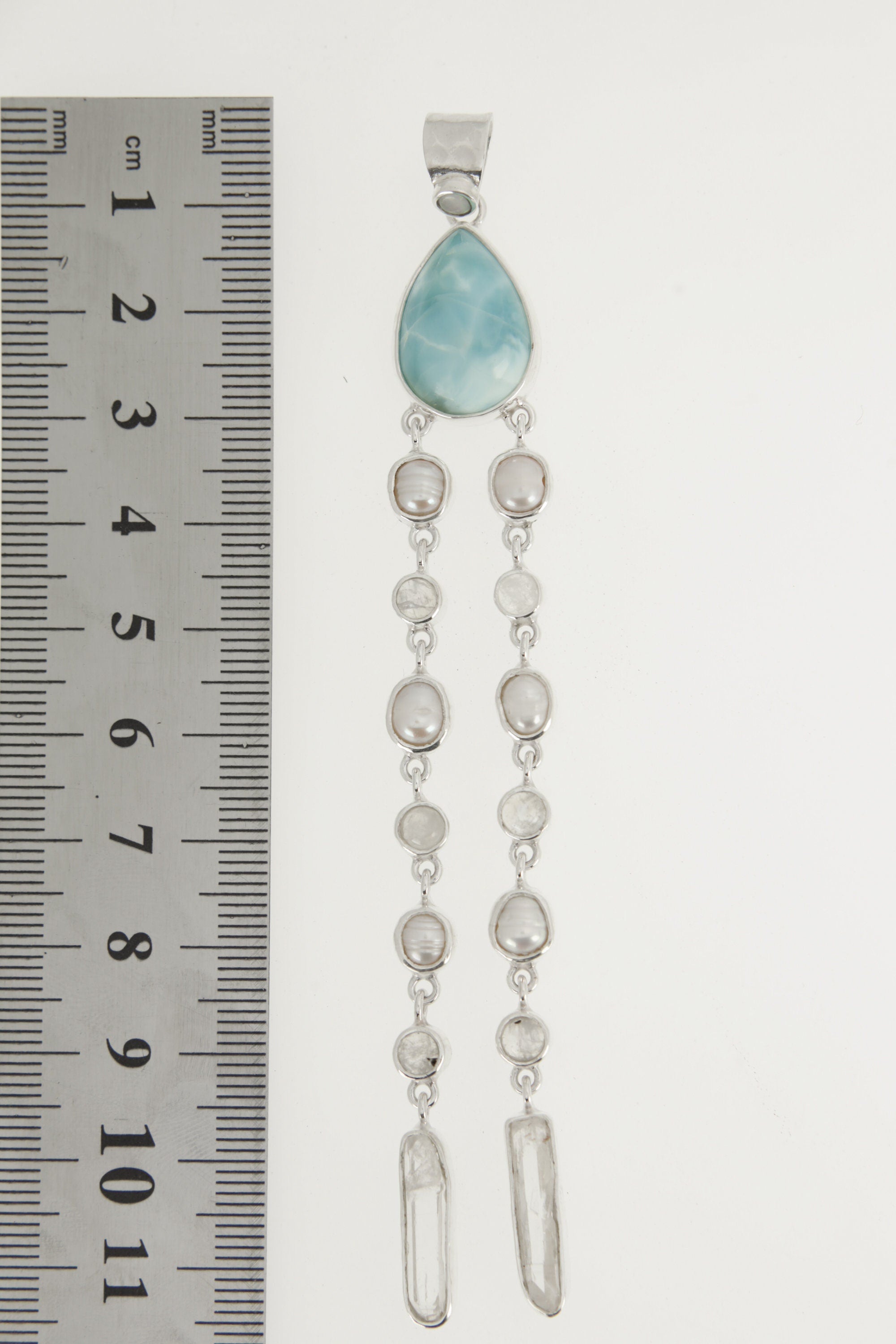 Lightning Ridge Opal Larimar Pearl Moonstone Quartz pendant shown beside a ruler for scale with long vertical crystal layout.