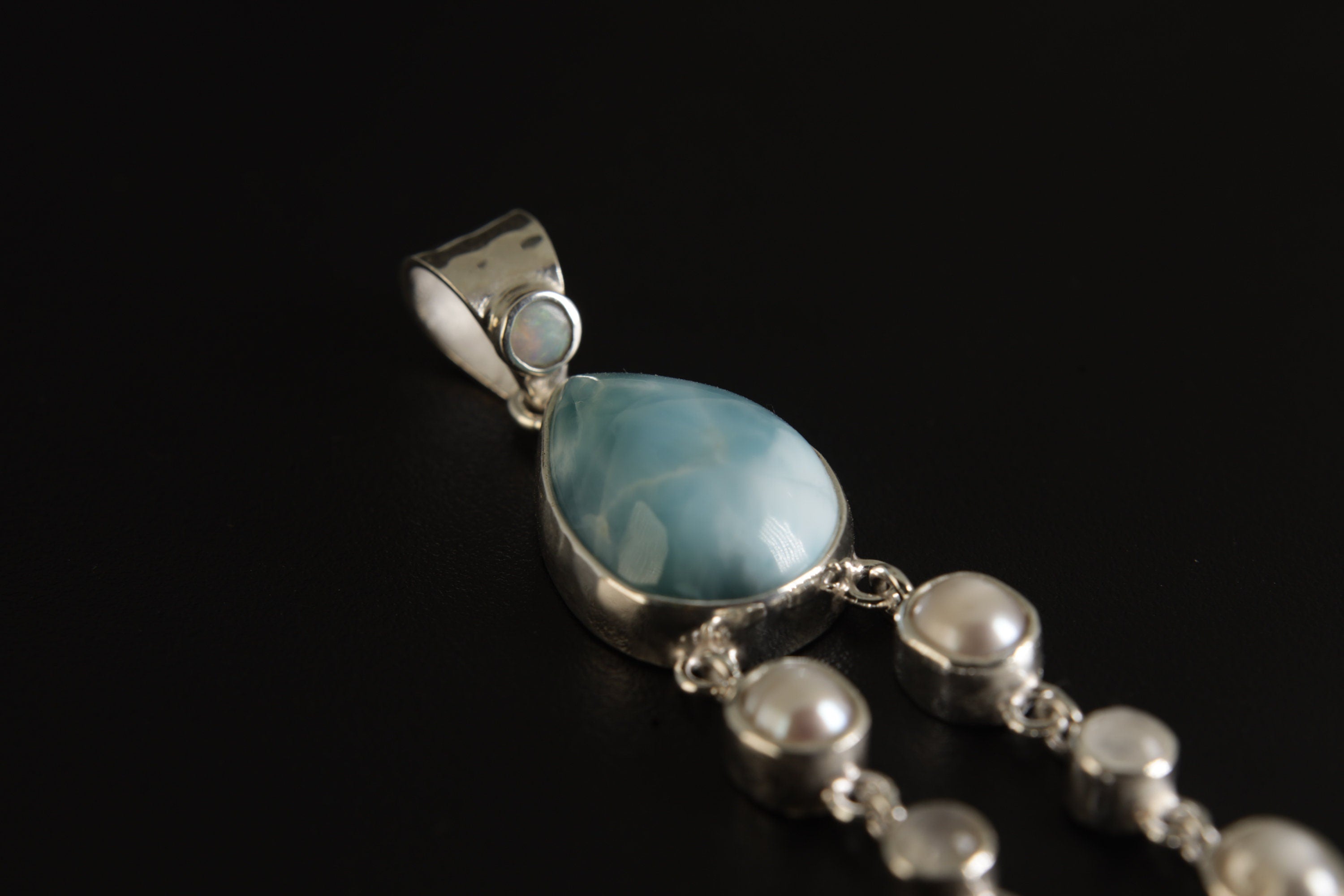 Lightning Ridge Opal Larimar Pearl Moonstone Quartz pendant shown on a dark background with triangular Opal bail and Pearl details.