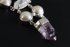 Close-up of South Sea Pearls, Cat’s Eye Moonstone, and Vera Cruz Amethyst point in a 925 sterling silver pendant.