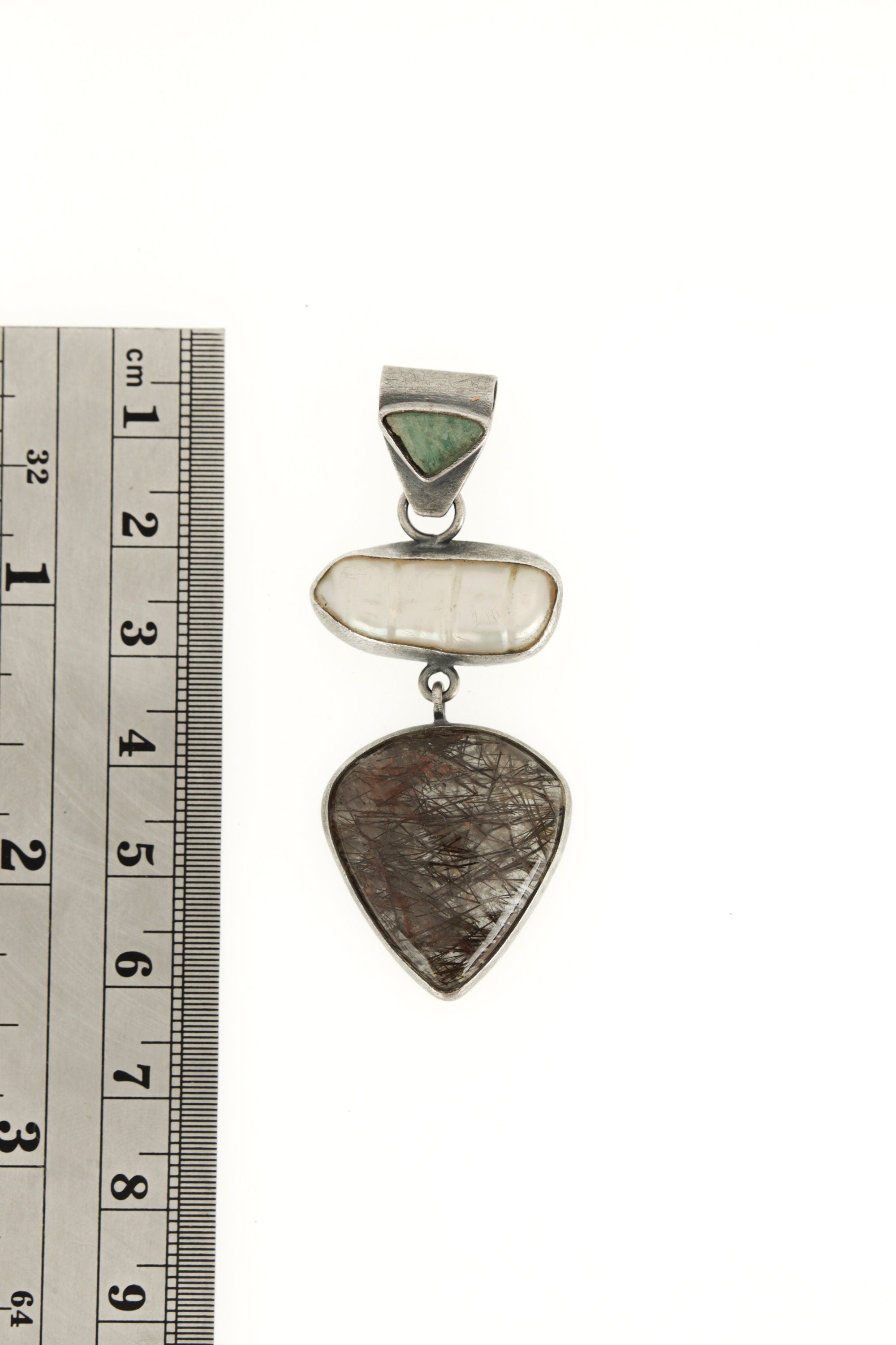 South Sea Pearl Black Rutile Quartz pendant shown beside a ruler for scale with handmade silver setting.