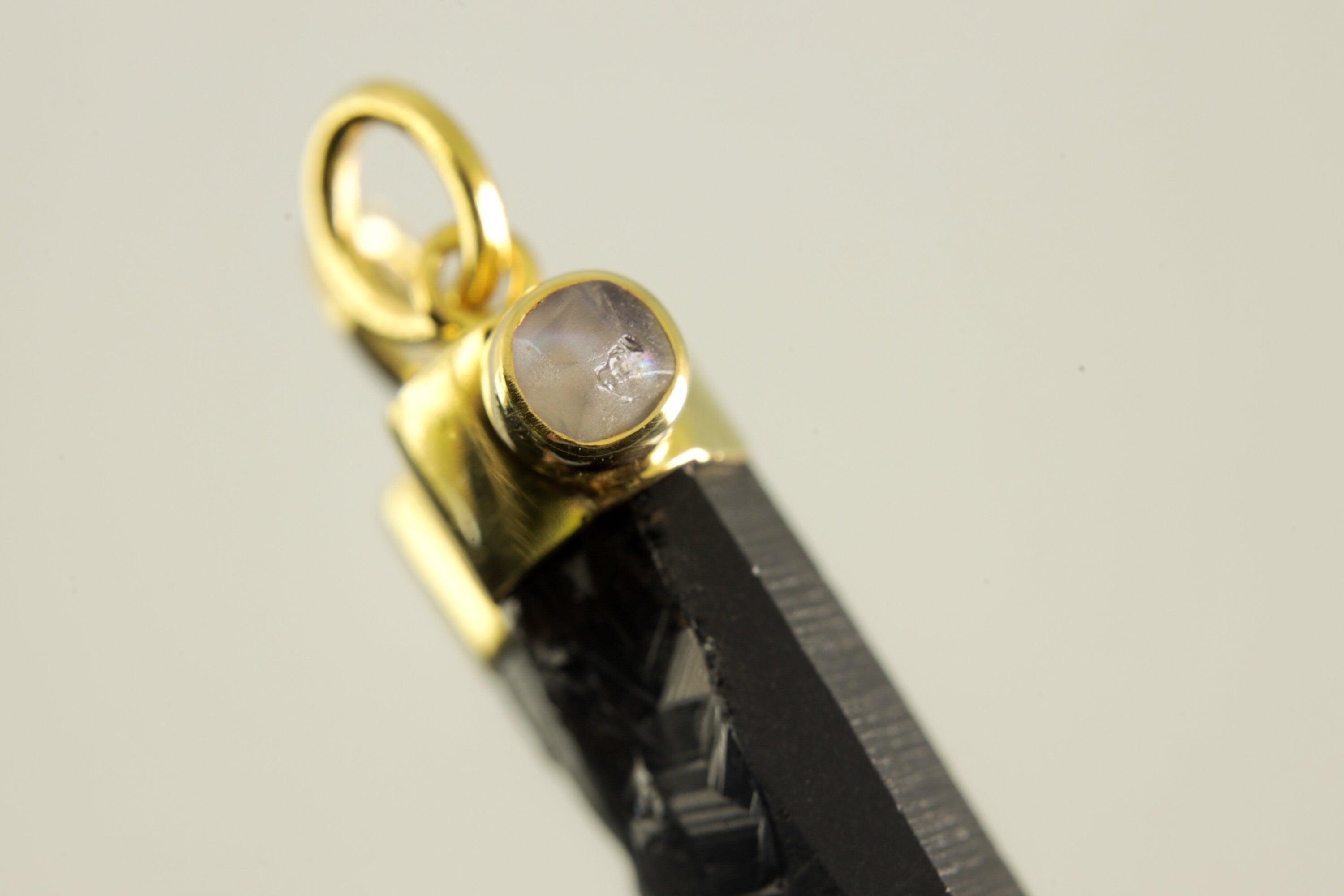 Detailed view of Blue Moonstone cabochon set into gold-plated sterling silver cap above Smoky Phantom Quartz.