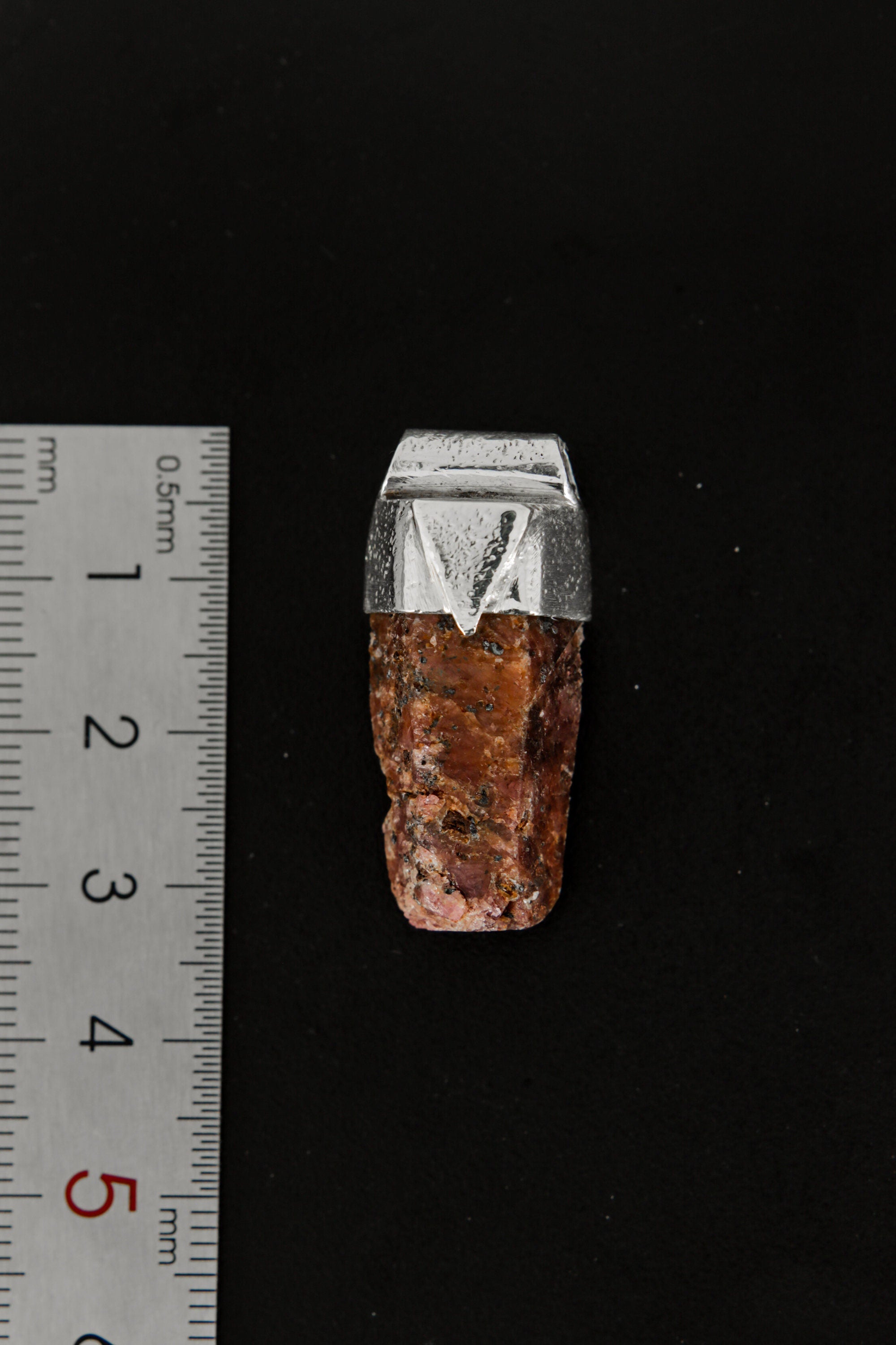 Hexagonal Ruby Stack Pendant shown beside a ruler for scale, measuring approximately 3.5 cm long.