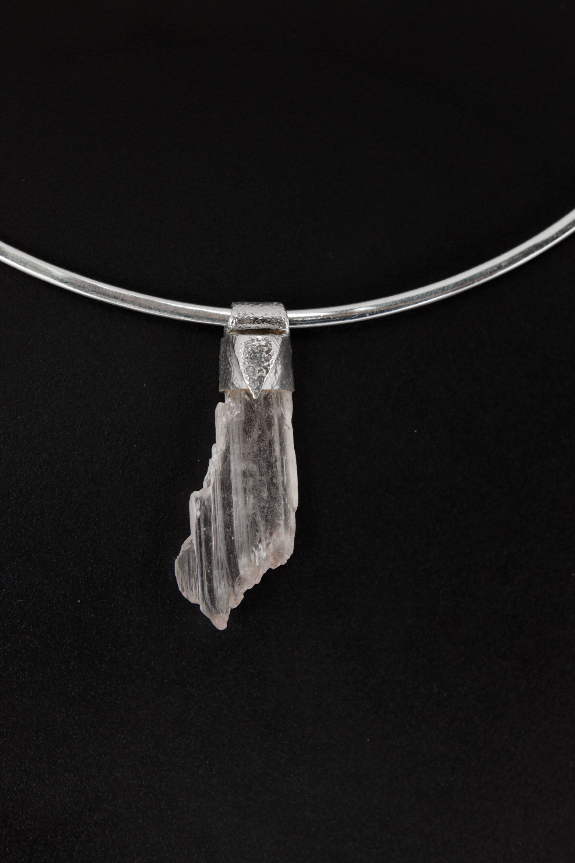 Specimen Crystal Stack Pendant shown on black background with sterling silver cap and natural crystal body.