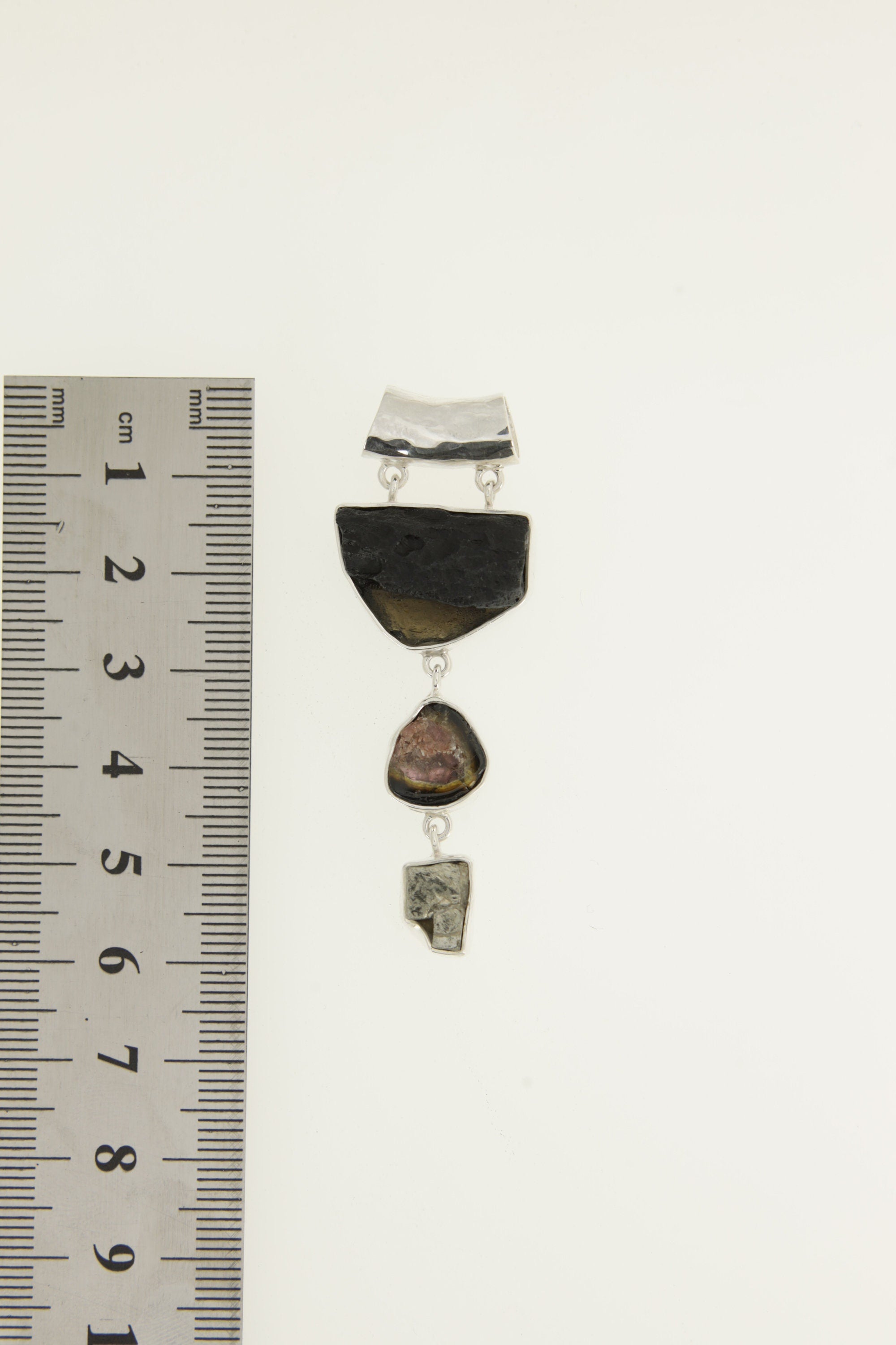 Mount Darwin Tektite Watermelon Tourmaline Pyrite pendant shown beside a ruler for scale, measuring approximately 6 cm long.