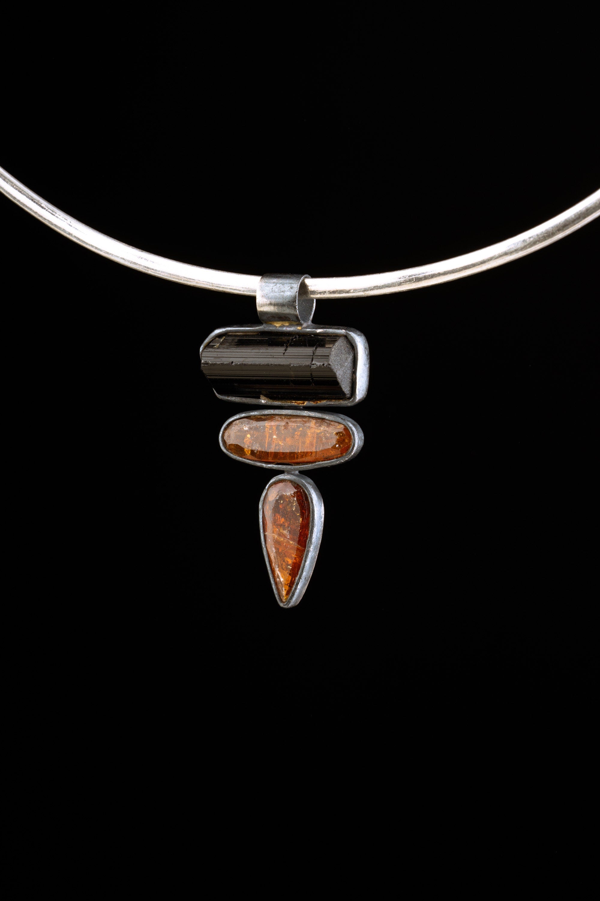 Black Tourmaline Red Kyanite pendant displayed on a choker, showing compact 4 cm talisman styling.