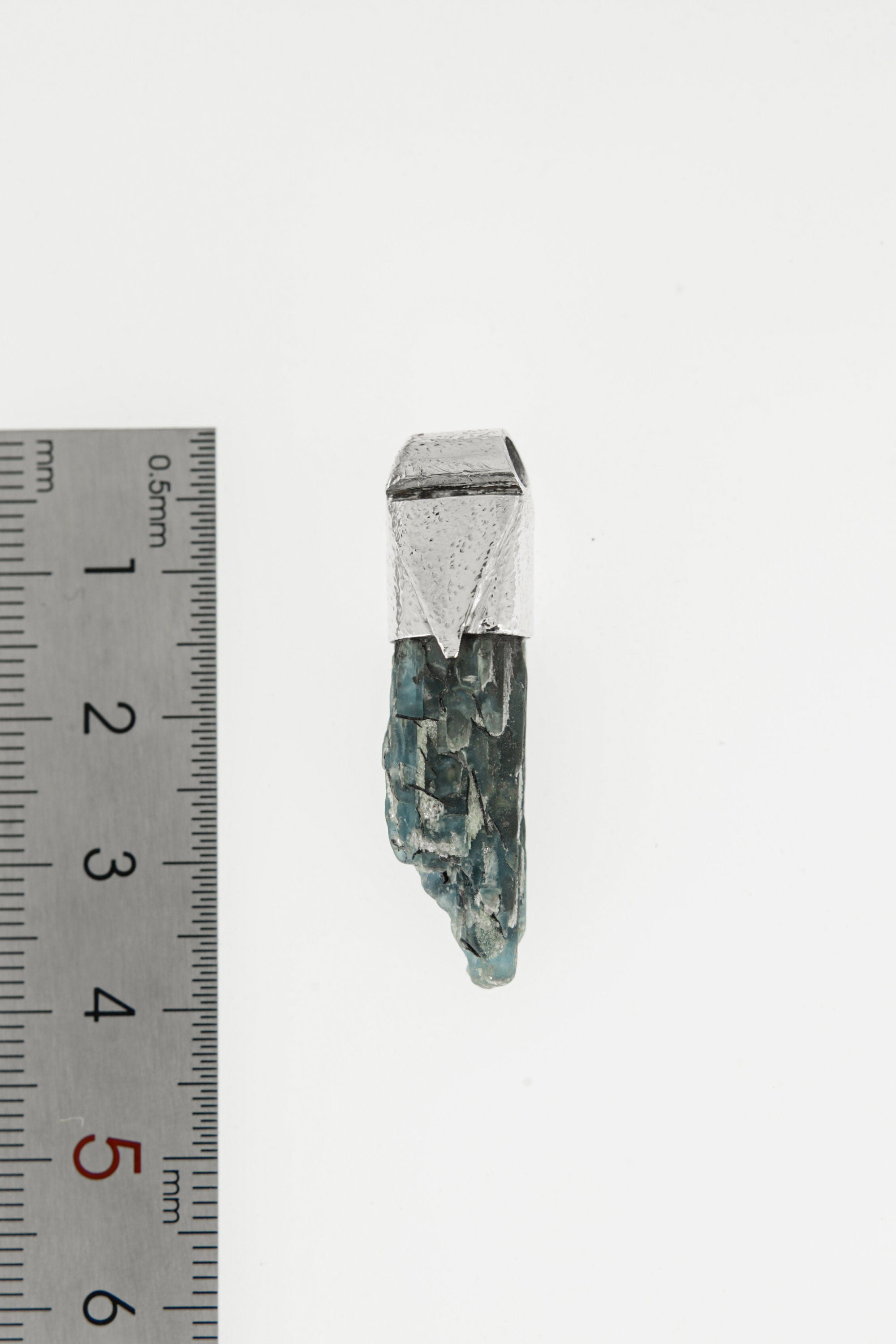Australian Ocean Kyanite Stack Pendant shown beside a ruler for scale with 925 silver cap and blue crystal body.