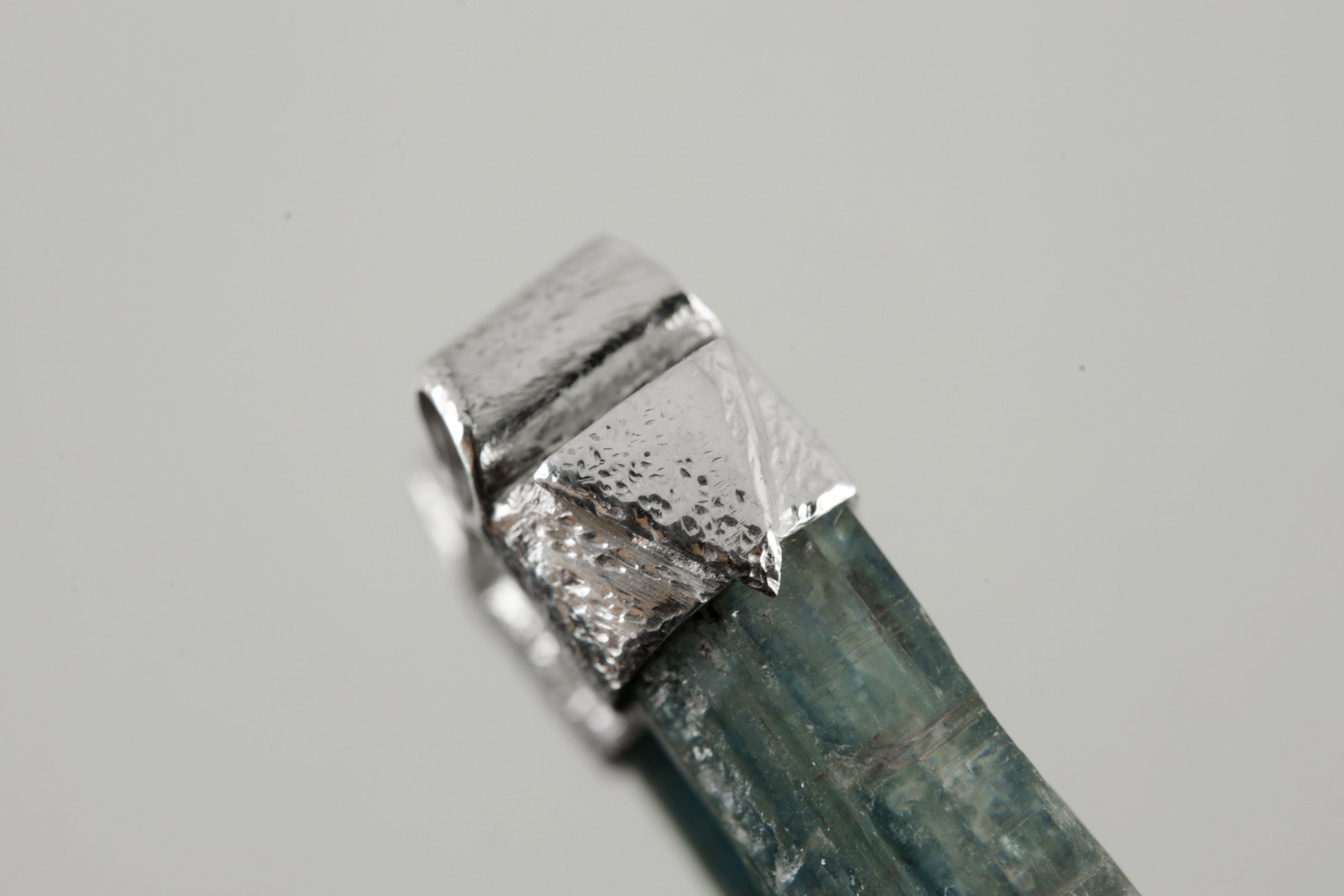 Close-up of natural Kyanite in a handmade sterling silver Stack Pendant cap with signature triangle detail.