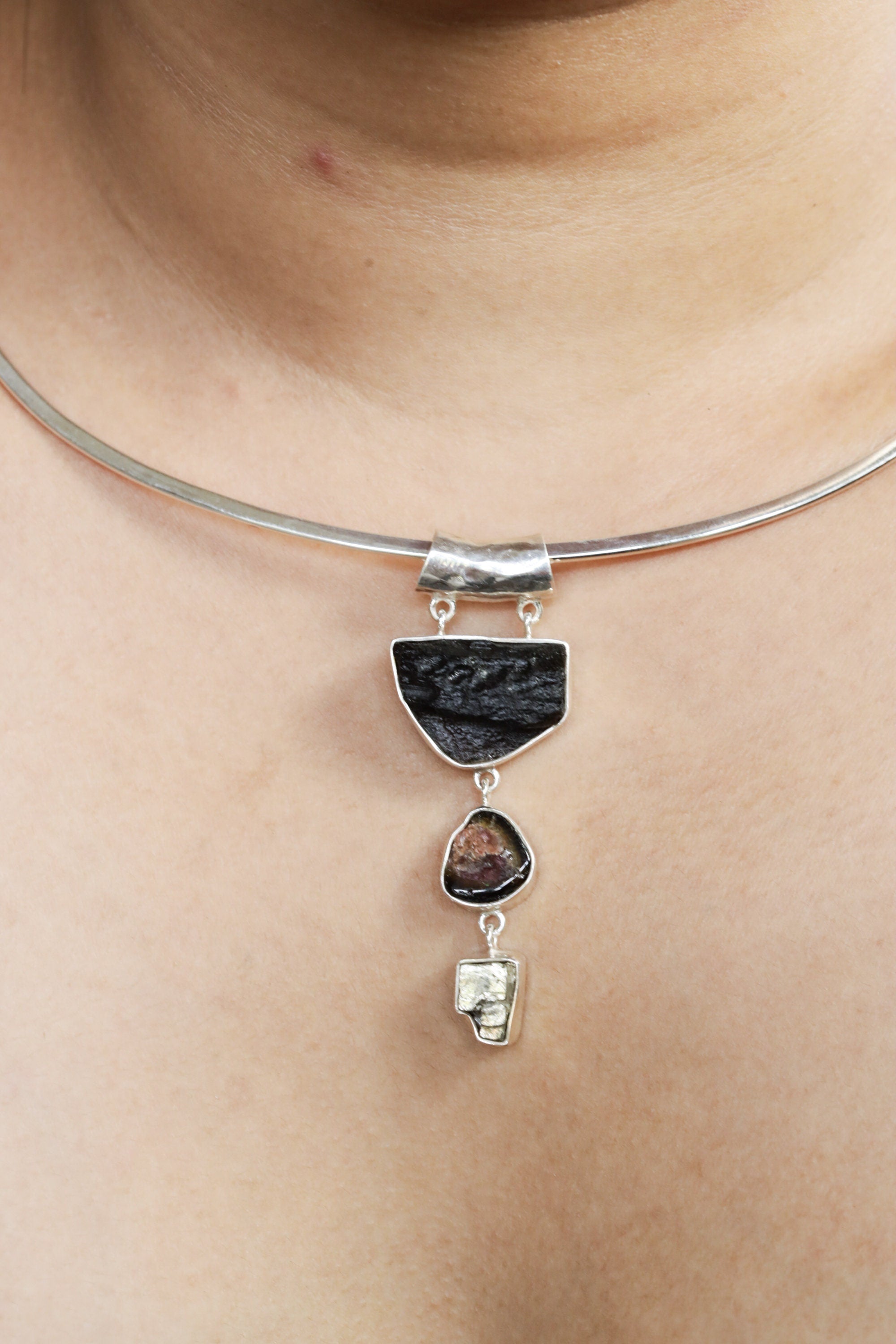 Mount Darwin Tektite Watermelon Tourmaline Pyrite pendant shown worn on a silver choker, with hammered sterling silver texture.