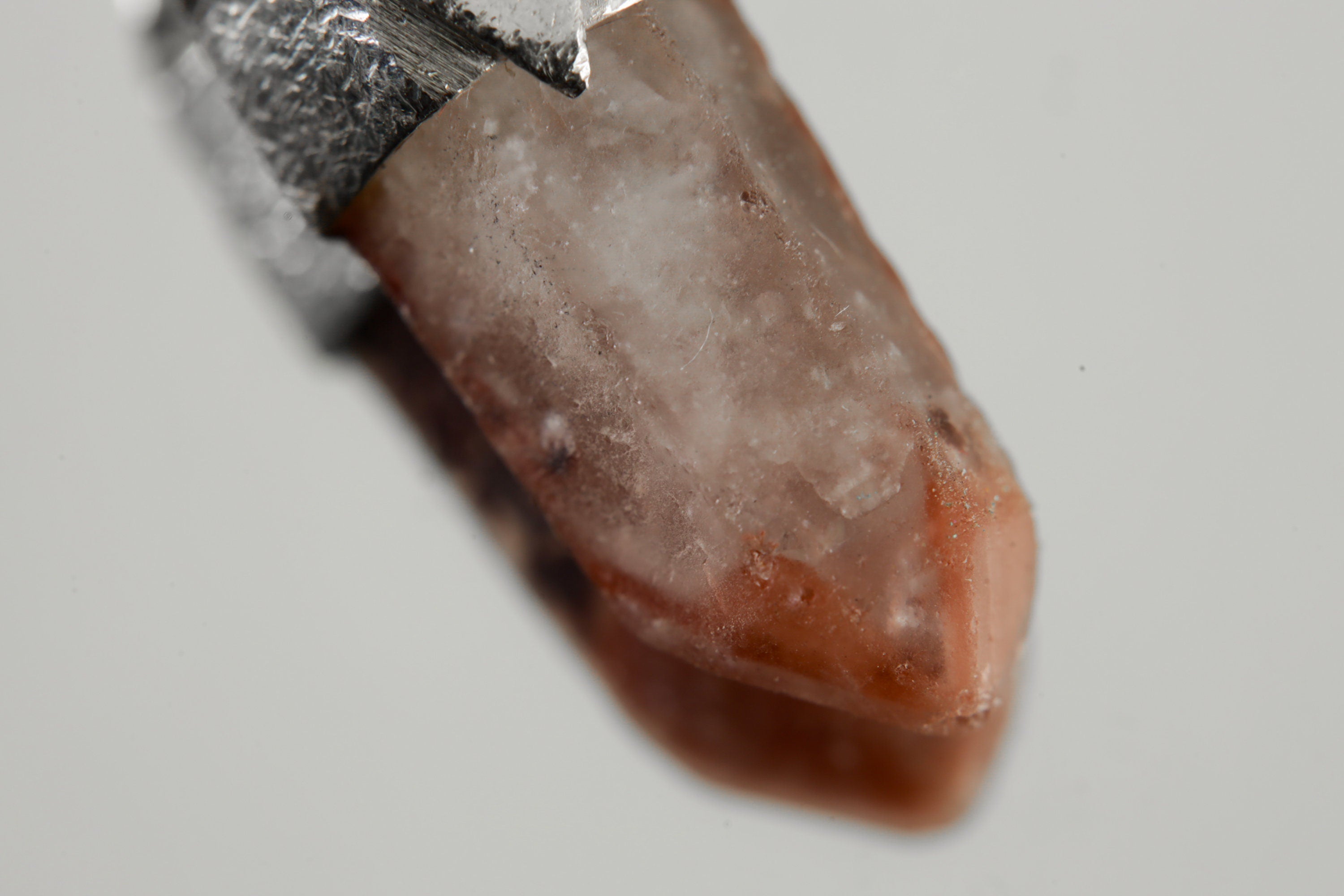 Close-up of Australian Phantom Lithium Quartz with soft lithium-bearing inclusions and handmade sterling silver cap.