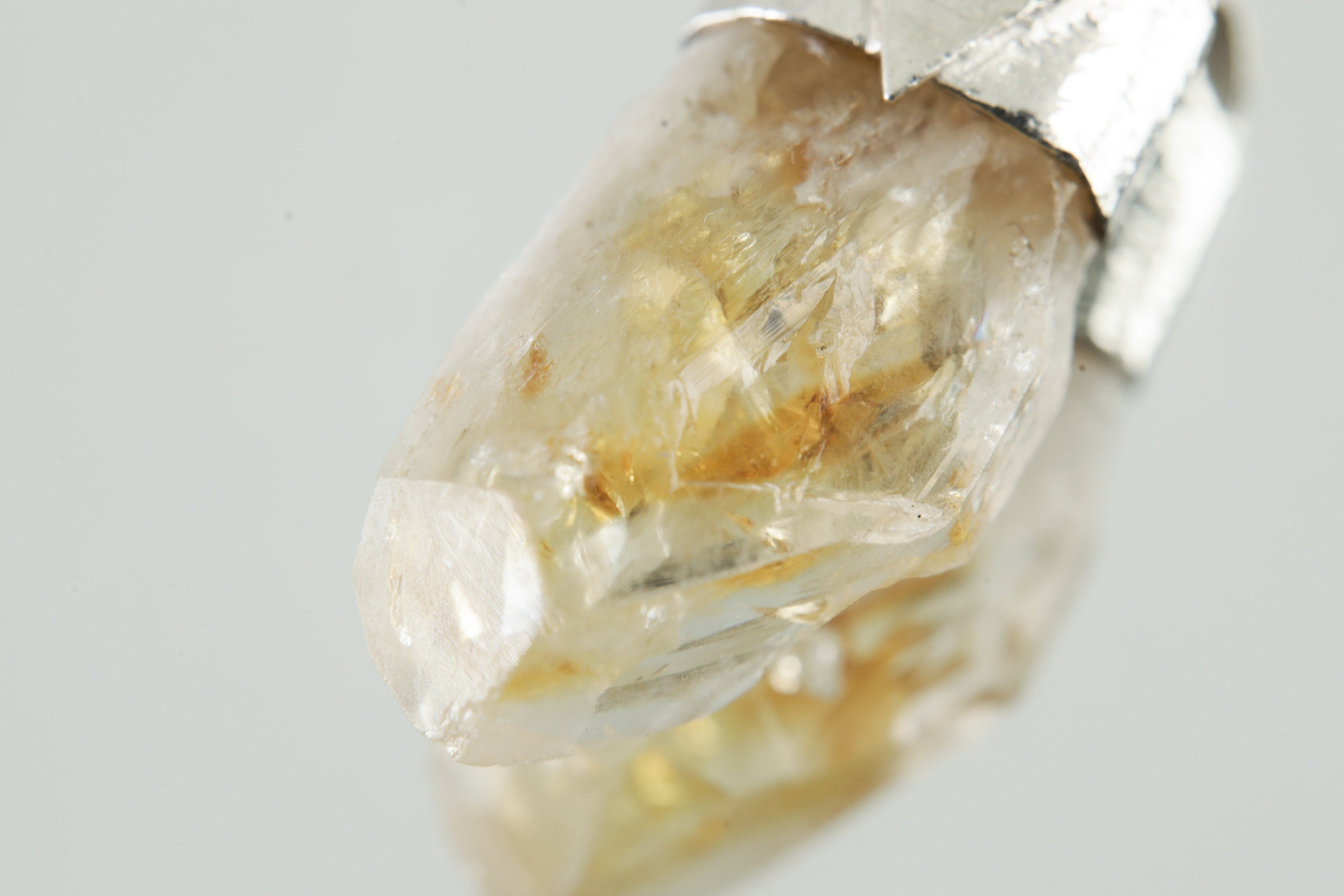 Close-up of Natural Phantom Citrine Quartz showing golden smoky colour, internal growth layers, and natural crystal point.